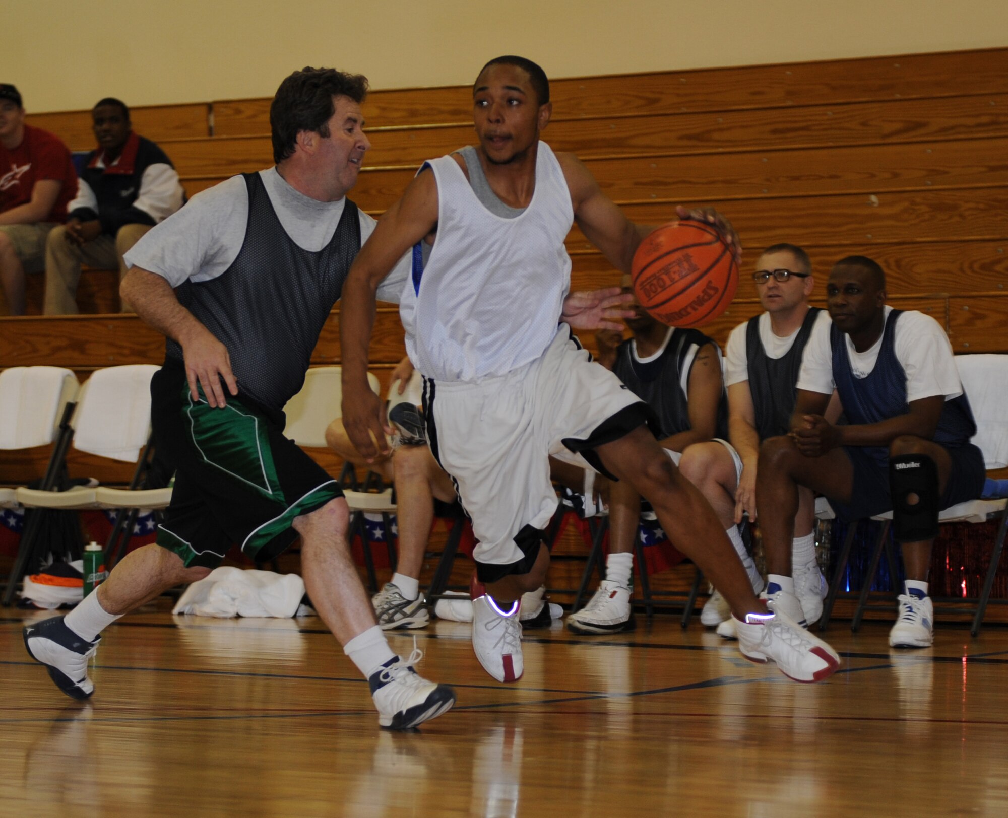 MOUNTAIN HOME AIR FORCE BASE, Idaho -- Clark Williams, intramurals all-star team, drives to the basket with Allen Niksich, over 30 all-star team, following close behind during the All Star Basketball Extravaganza at the Gunfighter Fitness Center March 20. The intramurals all-star team defeated the over 30 all-star team 61 to 43. (U.S. Air Force photo/Airman 1st Class Renishia Richardson)