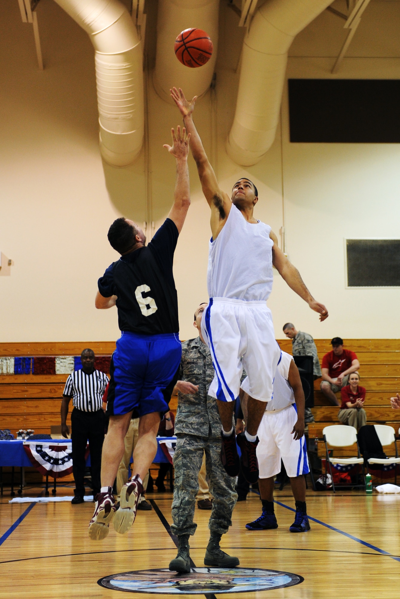 MOUNTAIN HOME AIR FORCE BASE, Idaho – Jay Jaques, over 30 all-star team, and Patrick McIntyre, intramurals all-star team, reach for the ball during the ceremonial tip off by Col. Jeffrey Maxwell, 366th Mission Support Group commander, at the All Star Basketball Extravaganza at the Gunfighter Fitness Center March 20. The intramurals all-star team defeated the over 30 all-star team 61 to 43. (U.S. Air Force photo/Senior Airman Ryan Crane)