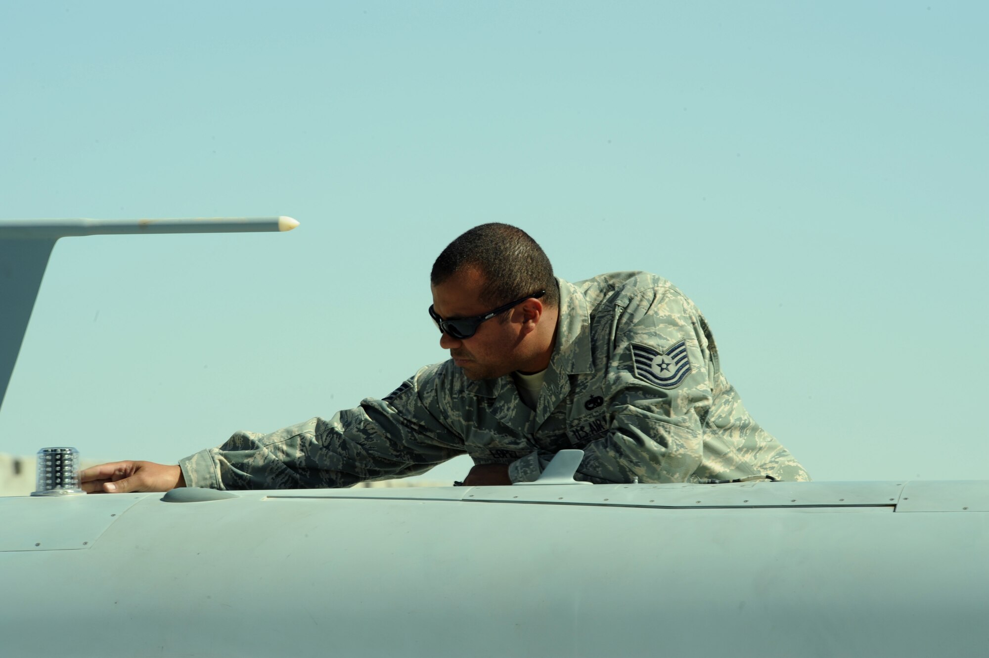 U.S. Air Force Tech. Sgt. Ismael Lopez, 62nd Expeditionary Reconnaissance Squadron quality assurance technician, inspects an MQ-9 Reaper for cracks and other damage at Kandahar Air Base, Afghanistan, March 13, 2009, in support of Operation Enduring Freedom.  (U.S. Air Force photo by Staff Sgt. James L. Harper Jr.)