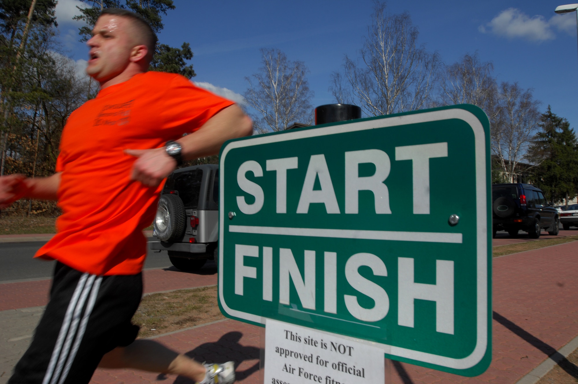 An Airman crosses the finish line during the 5K LOVESWEET memorial run, March 18, 2009, Ramstein Air Base, Germany. The run was in honor of Tech. Sgt. Jessica Sweet, 435th Communication Squadron supply troop, who lost a hard fought battle to Acute Myelogeneous Leukemia Feb. 12 (U.S. Air Force photo by Airman 1st Class Kenny Holston)