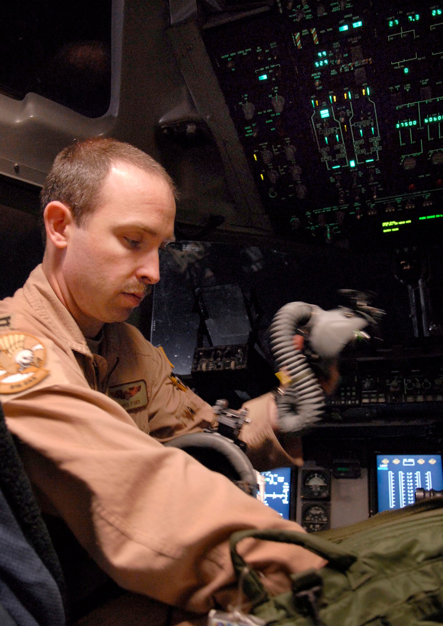 Capt. Christopher Ford, an 816th Expeditionary Airlift Squadron pilot, inspects his equipment during pre-flight checks in a C-17 Globemaster III, March 23, 2009 at an undisclosed location in Southwest Asia.  Capt. Ford and his crew helped guide a KC-135R Stratotanker crew, who had lost navigational capability over Afghanistan, to a safe landing at Bagram Air Base, Afghanistan March 16, 2009.  Capt. Ford hails from Albany, Ga. and is deployed from Charleston Air Force Base, S.C. in support of Operations Iraqi and Enduring Freedom and Combined Joint Task Force - Horn of Africa.  (U.S. Air Force photo/Senior Airman Andrew Satran/released)
