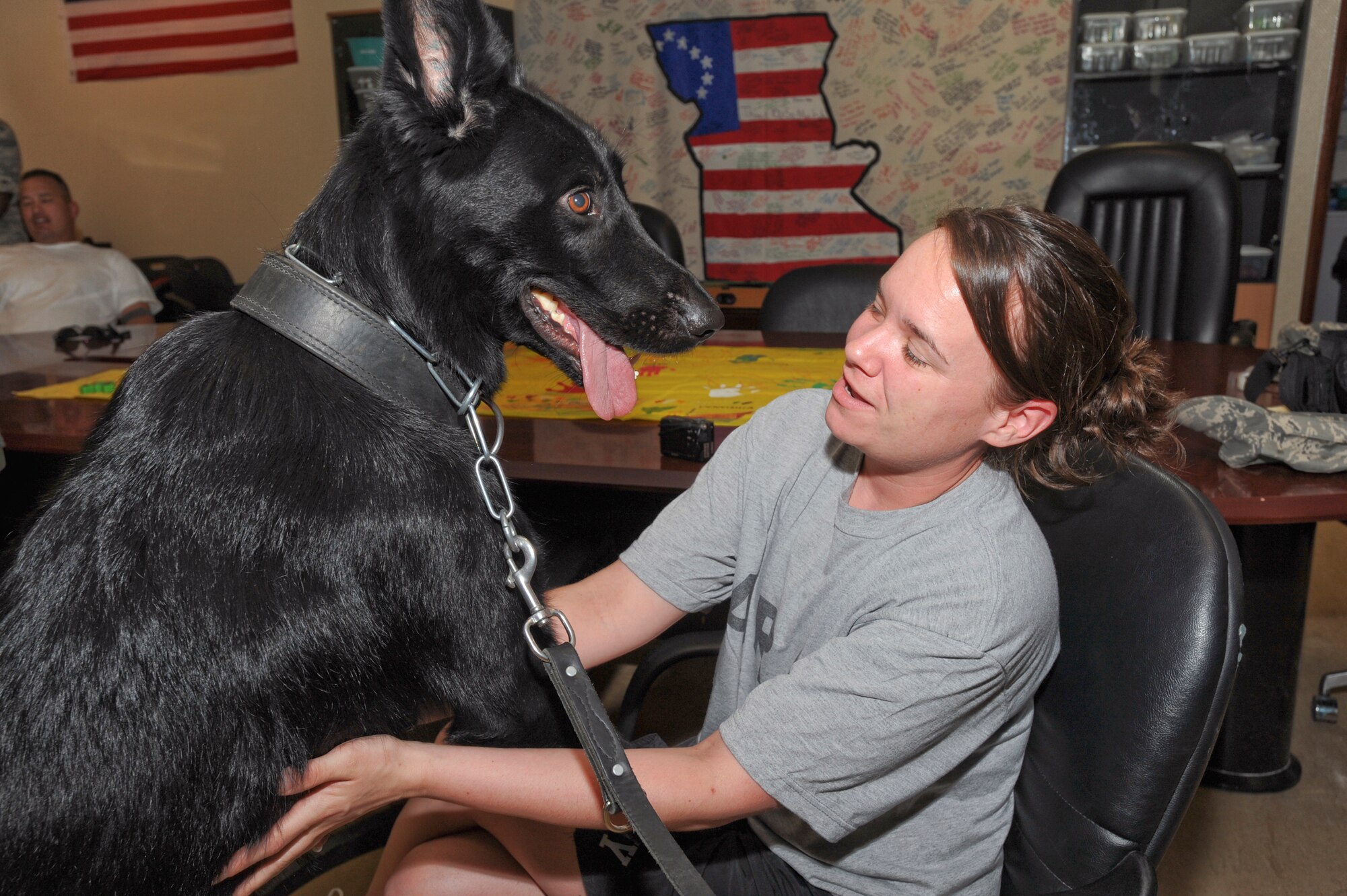 Argo, a military working dog with the 379th Expeditionary Security Forces Squadron, plays with Private 1st Class Beverly King, from the 172nd Support Battalion, March 24, 2009, in an undisclosed location in Southwest Asia.  Private King is enrolled in the In Theater Care Program which uses various events and services like this to assist patients recovering from minor surgeries or other medical problems. Private King is native to Elkhart, Ind. and deployed from Conn Barracks, Germany and Argo is handled by SSgt Brandi Throgmorton, both are deployed from Hill Air Force Base, Utah, in support of Operations Iraqi and Enduring Freedom and Combined Joint Task Force - Horn of Africa.  (U.S. Air Force Photo by Staff Sgt. Joshua Garcia/released)