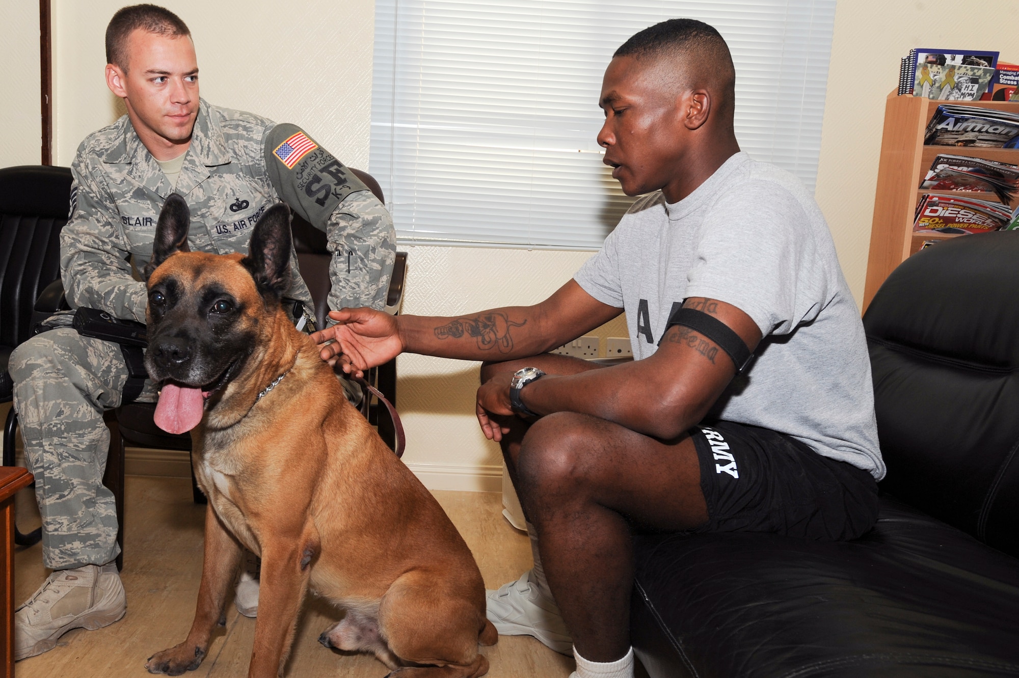 Staff Sgt. Randall Blair, a K-9 Handler with the 379th Expeditionary Security Forces Squadron, briefs Army Staff Sgt. Kaviraz German, from Fort War Horse, Iraq, on his Military Working Dog, Midas, March 24, 2009, in an undisclosed location in Southwest Asia.  Sergeant German is enrolled in the In Theater Care Program which uses various events and services like this to assist patients recovering from minor surgeries or other medical problems.  Sergeant Blair is originally from Richmond, Va. and is deployed out of Shaw Air Force Base, S.C. with Midas.  Sergeant German is native to Fairbanks, Alaska and is deployed out of Fort Wayne-Wright, Alaska, all of them in support of Operations Iraqi and Enduring Freedom and Combined Joint Task Force - Horn of Africa.  (U.S. Air Force Photo by Staff Sgt. Joshua Garcia/released)