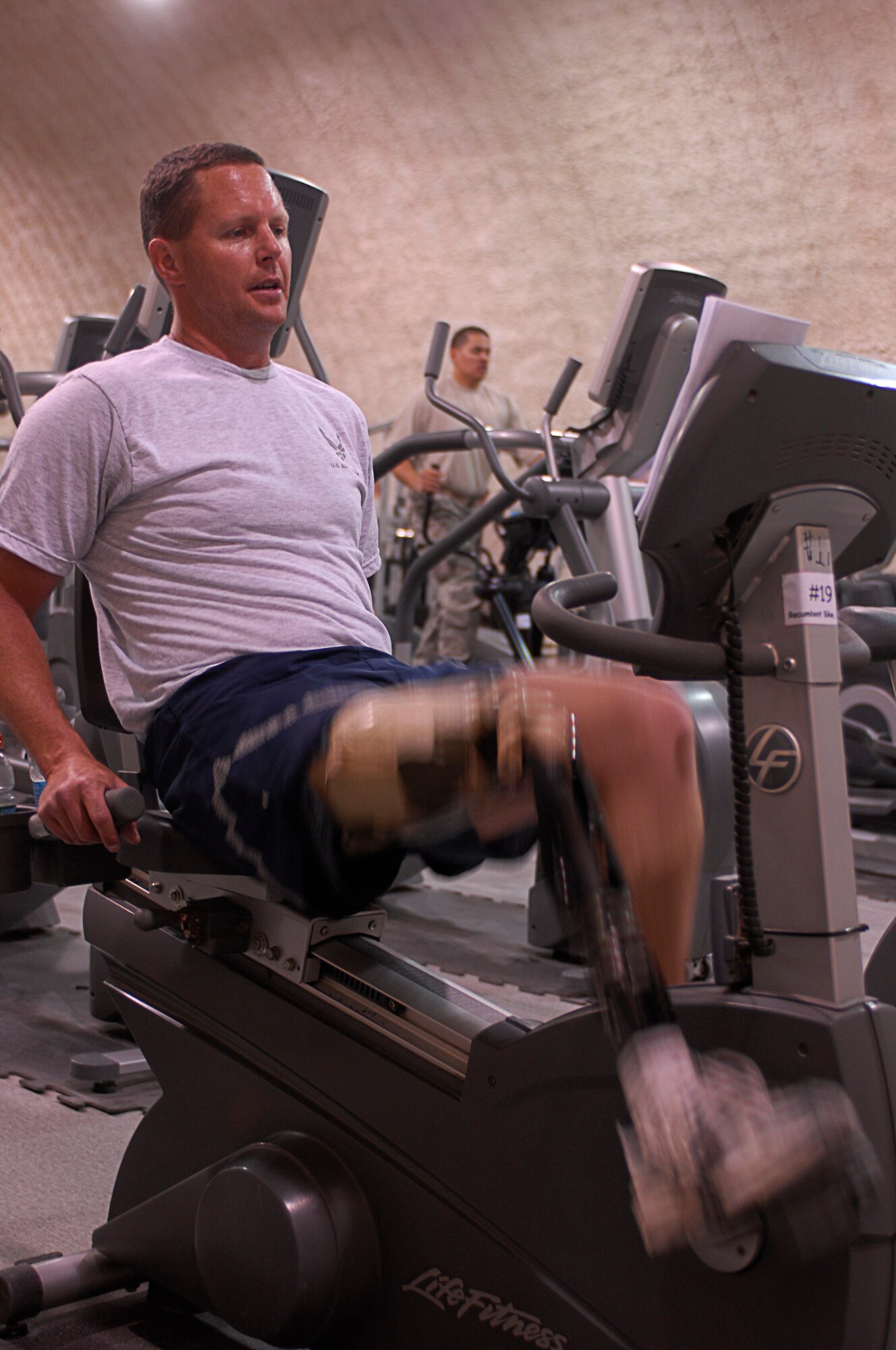 Maj. Alan Brown, 774th Expeditionary Airlift Squadron, rides a stationary bicycle at Bagram Air Field, Afghanistan, March 21. Major Brown is an amputee C-130 Pilot, deployed from the 187th Airlift Squadron, Wyoming Air National Guard, Cheyenne, Wyo. He lost his leg in a hunting accident 10 years ago and after seven years regained his qualifcations to fly. Major Brown works out daily riding the stationary bike using a custom strap developed by the Unit's life support crew. (U.S. Air Force photo/ Senior Airman Erik Cardenas)(Released)