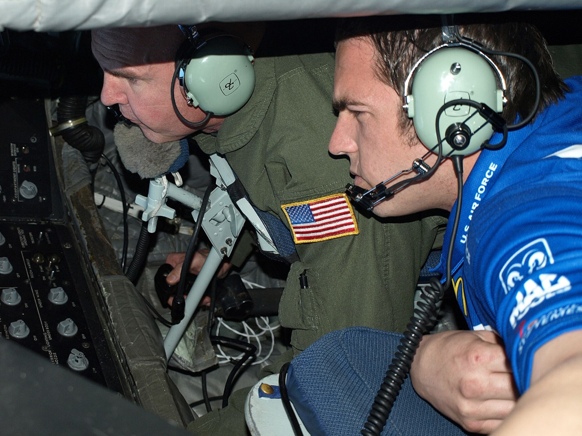 SEYMOUR JOHNSON AIR FORCE BASE, N.C. -- Tech. Sgt. Steve Stanton (left) shows a member of the Richard Petty Race Team the view from the boom pod at 20,000 feet.