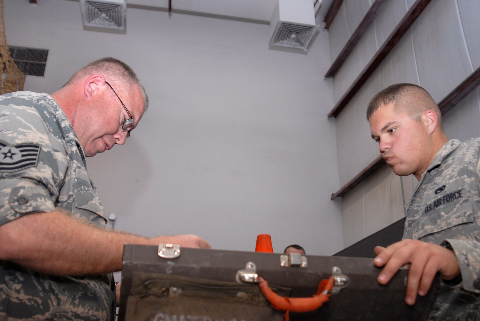 Tech. Sgt. Christopher Bond and Senior Airman Benjamin Bond, both 340th Aircraft Maintenance Unit KC-135R Crew Chiefs who also happen to be father and son, check tools and equipment before going to their aircraft, March 23, 2009, at an undisclosed location in Southwest Asia.  The father and son team hail from Bunker Hill, Ind. and are deployed from Grissom Air Reserve Base, Ind. in support of Operations Iraqi and Enduring Freedom and Combined Joint Task Force - Horn of Africa.  (U.S. Air Force photo/Senior Airman Andrew Satran/released)