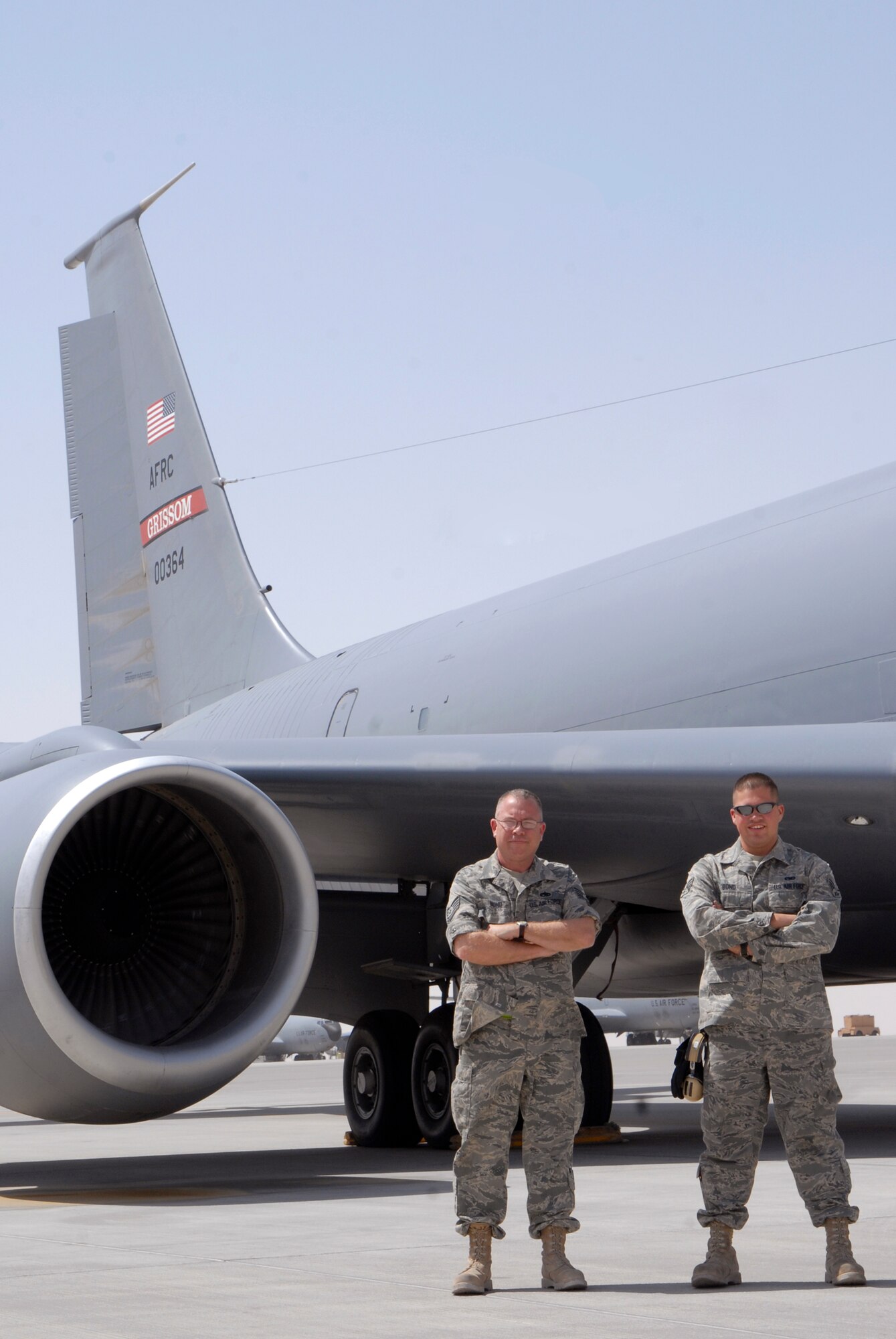 Tech. Sgt. Christopher Bond and Senior Airman Benjamin Bond, both 340th Aircraft Maintenance Unit KC-135R Crew Chiefs who also happen to be father and son, stand in front of an aircraft from their home station, March 23, 2009, at an undisclosed location in Southwest Asia.  The father and son team hail from Bunker Hill, Ind. and are deployed from Grissom Air Reserve Base, Ind. in support of Operations Iraqi and Enduring Freedom and Combined Joint Task Force - Horn of Africa.  (U.S. Air Force photo/Senior Airman Andrew Satran/released)
