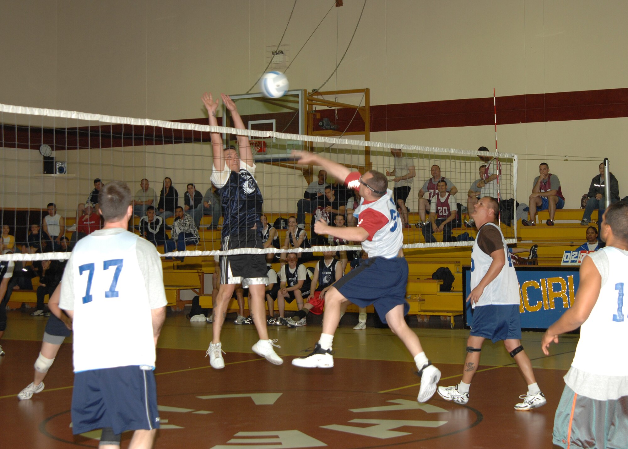 Jason Crouch, 39th Communications Squadron volleyball team, blocks the spike of Jeffrey Katzman, 39th Civil Engineer Squadron volleyball team, during an intramural game at the Incirlik Fitness Center  Monday, March  23, 2009. The 39 CS team was defeated by the 39 CES team two games to one. (U.S. Air Force photo/Staff Sgt. Lauren Padden)