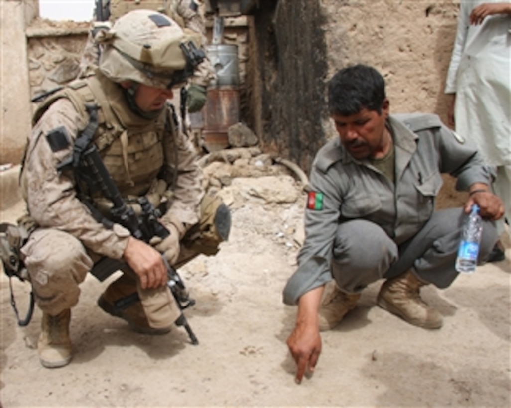 Commanding Officer 3rd Battalion, 8th Marine Regiment Lt. Col. David L. Odom, U.S. Marine Corps, and Abdul Majid, an Afghan National Police officer, discuss increased security measures being put in place in Delaram, Farah, Afghanistan, on March 23, 2009.  The increase is in response to the police station in Delaram being targeted by a vehicle-borne explosive device on March 20.  The Afghan National Police and Marines from 3rd Battalion, 8th Marine Regiment have partnered to root out insurgents in the Delaram area.  Odom is the commanding officer of the ground combat element for the Special Purpose Marine Air Ground Task Force-Afghanistan, which is helping to reconstruct and develop southern Afghanistan and provide security for the region's people.  