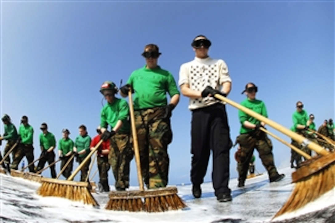 U.S. Navy Flight deck personnel scrub down the flight deck of the aircraft carrier USS John C. Stennis in the Pacific Ocean, March 23, 2009. The USS John C. Stennis and Carrier Air Wing 9 are on a scheduled six-month deployment to the western Pacific Ocean.