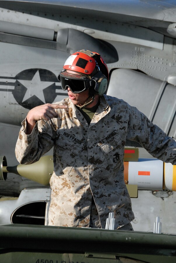 Cpl. Jacob Hoffpauir, Marine Attack Squadron 214 ordnance technician, guides 500-pound bombs for loading on an AV-8B Harrier March 25 at the Strategic Expeditionary Landing Field at Twentynine Palms, Calif.