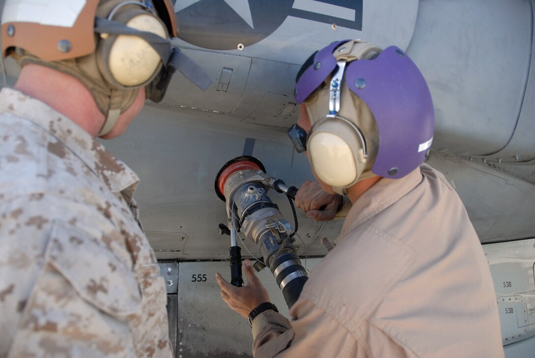 A Marine Wing Support Squadron 374 Marine refuels a Marine Attack Squadron 214 AV-8B Harrier at the Strategic Expeditionary Landing Field here, March 25. VMA-214 used MWSS-374's landing field to train in rapid ground refueling techniques for their upcoming deployment to Afghanistan.