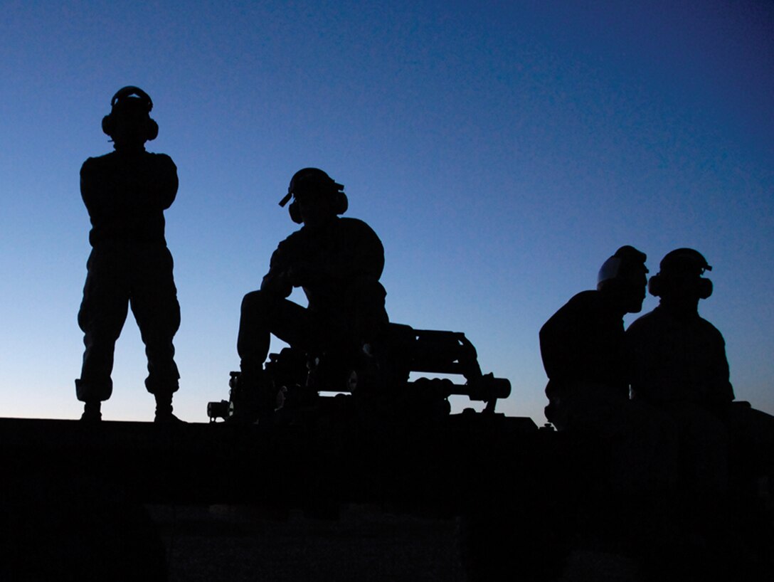 Marine Attack Squadron 214 ordnance technicians watch as their squadron's AV-8B Harriers take off from Strategic Expeditionary Landing Field here March 25.