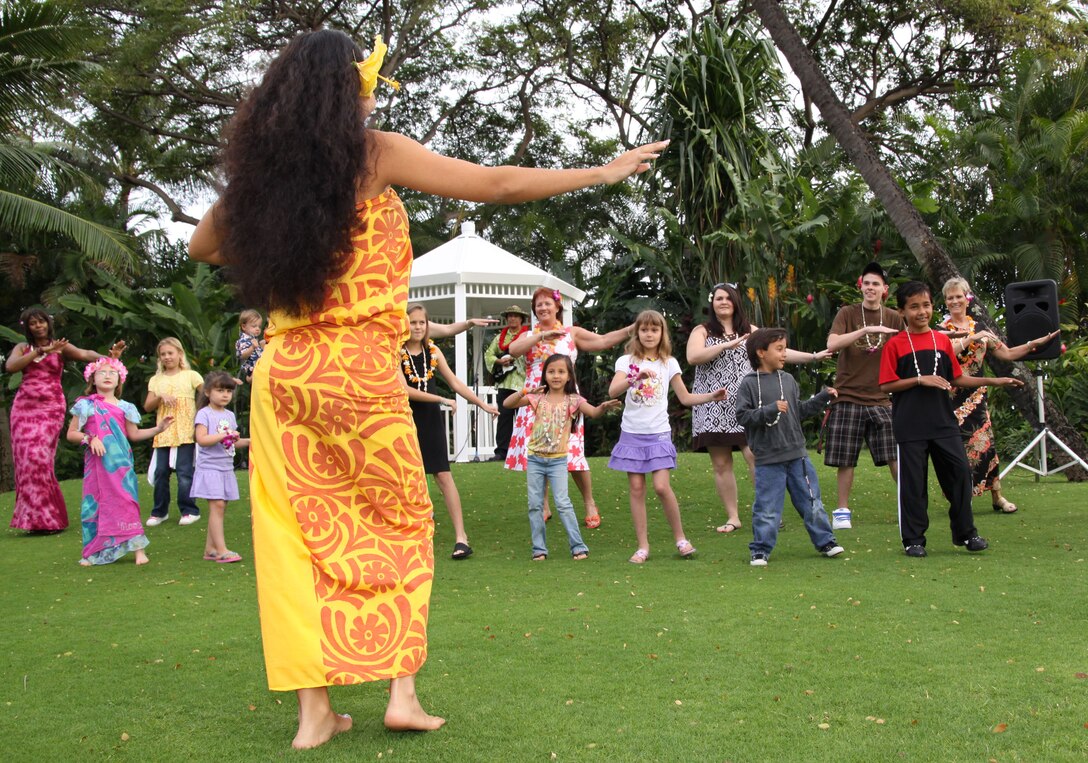 Michelle Kama, producer of the Hale Koa Hotel luau show, shows guests how to do the hula. During the four-hour evening, guests can experience the Polynesian culture interactively through food, dancing and crafts.