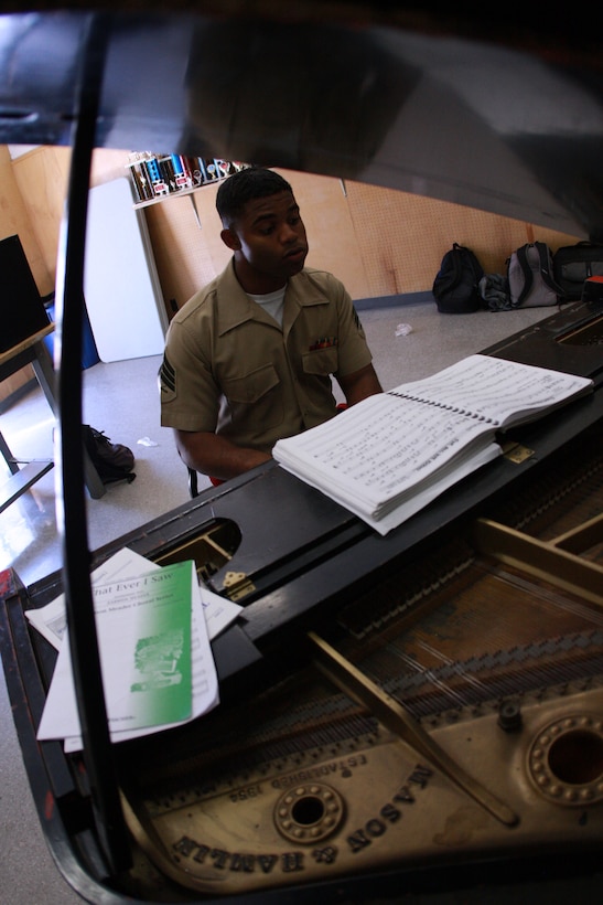 Sgt. Victor Diaz, a piano player with the Combat Center band, plays his bread and butter instrument along with the Yucca Valley High School band in Yucca Valley, Calif. The band visits local schools throughout the year to work with music students.