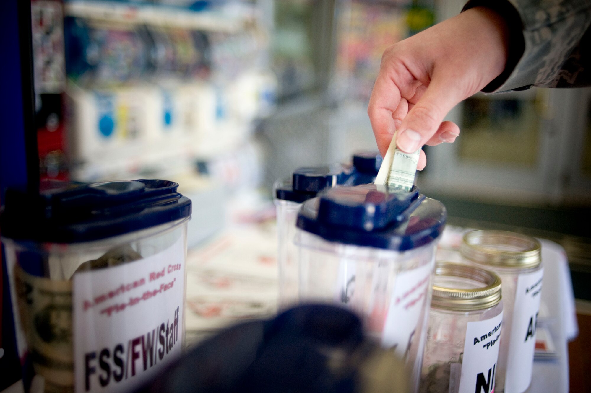 MISAWA AIR BASE, Japan -- Master Sgt. Clinton Stone, 35th Logistics Readiness Squadron, puts money into a jar designated for his squadron's first sergeant March 20, 2009. The donation goes to the American Red Cross detachment here. The owner of the jar with the most, and least, amounts of money will receive a pie in the face April 1. Sergeant Stone hails from Sacramento, Calif. (U.S. Air Force photo by Staff Sgt. Samuel Morse)