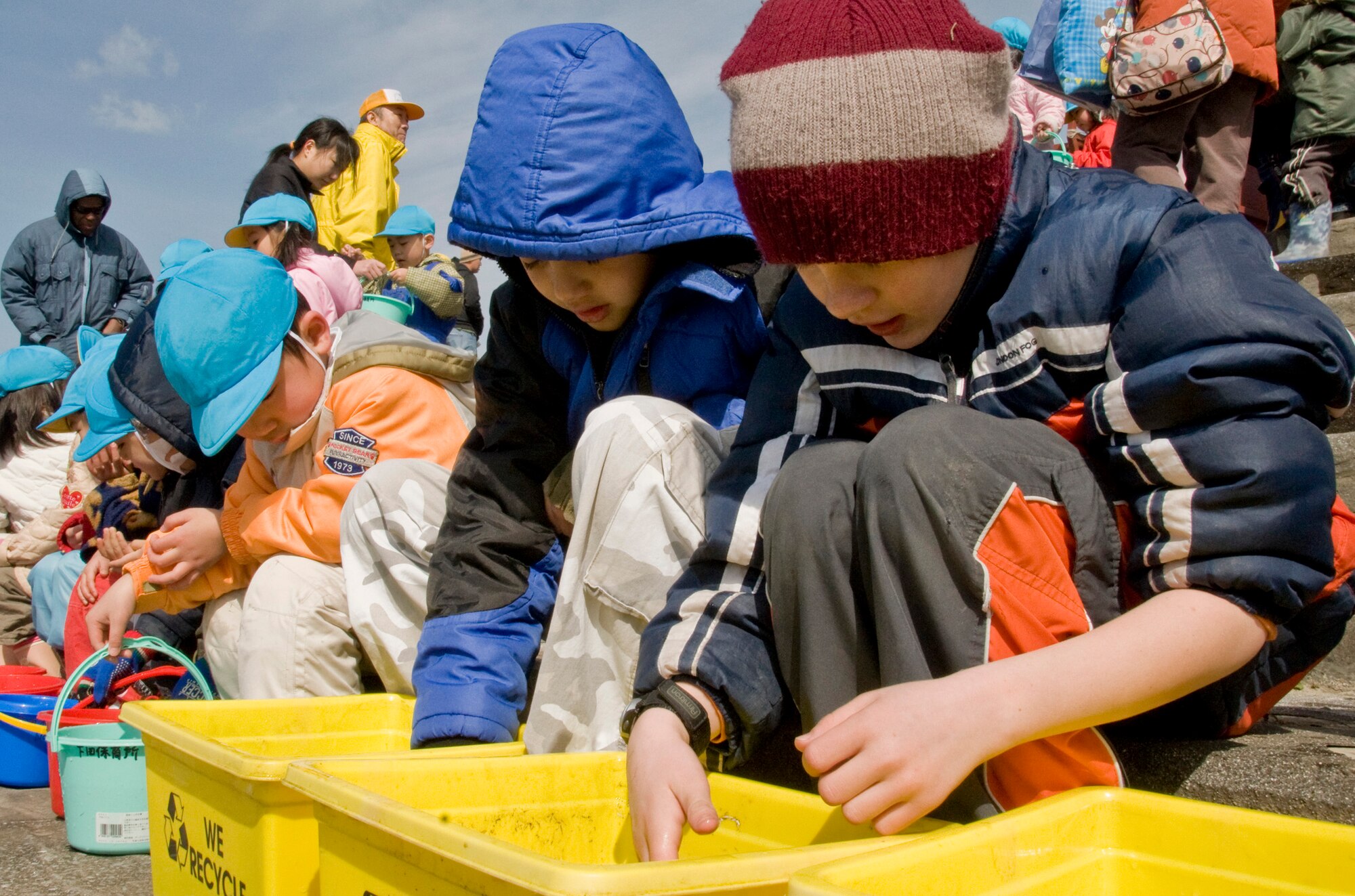 OIRASE TOWN, Japan -- Children play with baby salmon prior to releasing them March 21, 2009. As part of the 2009 Earth Day event, 300,000 salmon were released into the river. (U.S. Air Force photo by Staff Sgt. Araceli Alarcon)