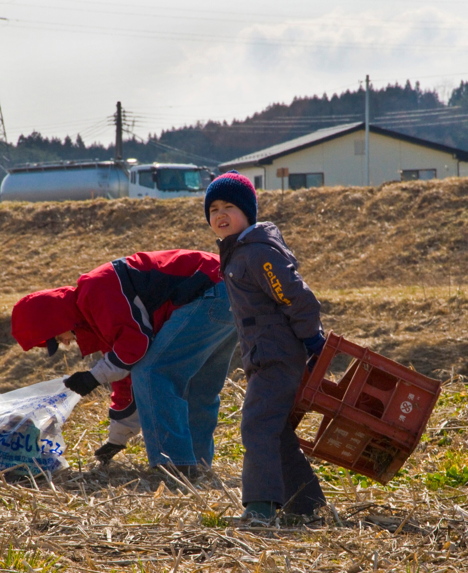 OIRASE TOWN, Japan -- Master Sgt. Jerome Bristow, 35th Maintenance Squadron, and his son Andrew pick up trash at Salmon Park March 21, 2009. The park clean up was done prior to releasing baby salmon into the Oirase river. (U.S. Air Force photo by Staff Sgt. Araceli Alarcon)