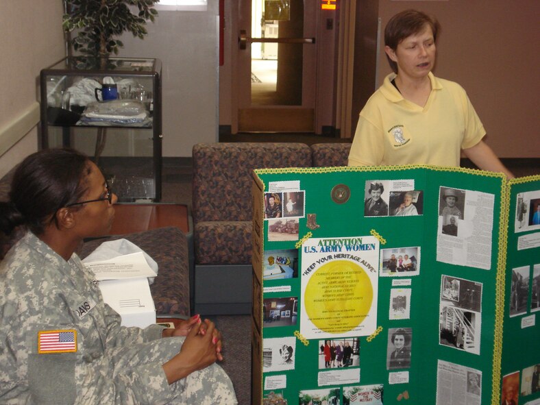 Mabel Pruett, the first Vice President of the Women’s Army Corps Veterans association, Chapter One, the founding chapter in Chicago, talks about the history of women in the Army, while Sgt. Davis listens. (U.S. Air Force photo by SSgt. Megan Crusher)