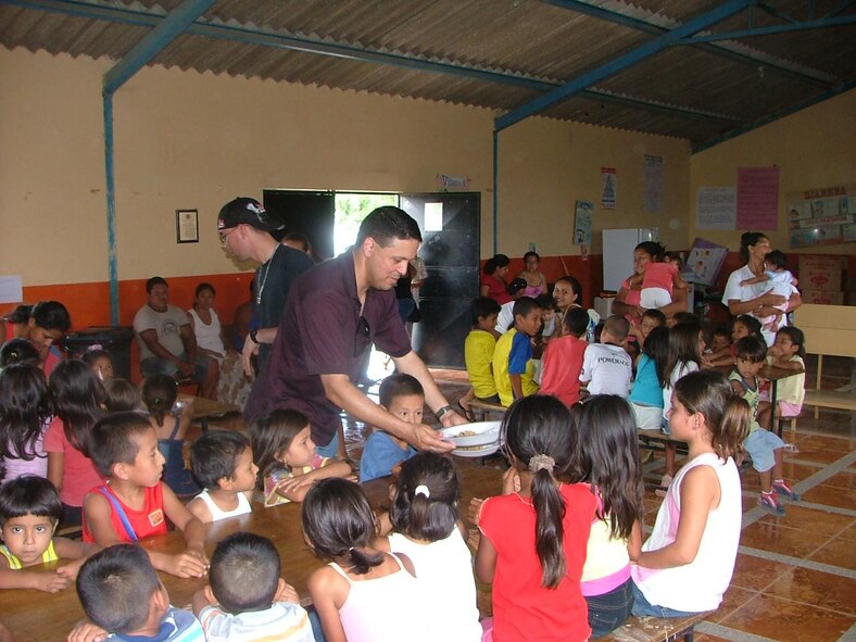 FORWARD OPERATING LOCATION MANTA, Ecuador -- Chaplain (Capt.) Gabriel Rios, deployed to FOL Manta from Spangdahlem Air Base, Germany, serves lunch to children at the Jesus de Nazareth community kitchen in Manta, Ecuador Feb. 27. A good portion of the chaplain’s work involves building partnerships with local organizations to make a lasting impact on the community outside the gates. (U.S. Air Force photo)