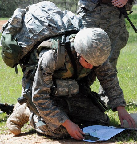 Airman 1st Class Ben Thomas, a 9th CES EOD technician, checks coordinates on a map during a training exercise March 24. The EOD team used maps, ca compass and GPS devices to find the location of a weapons cache. (Photo by Airman 1st Class Chuck Broadway)