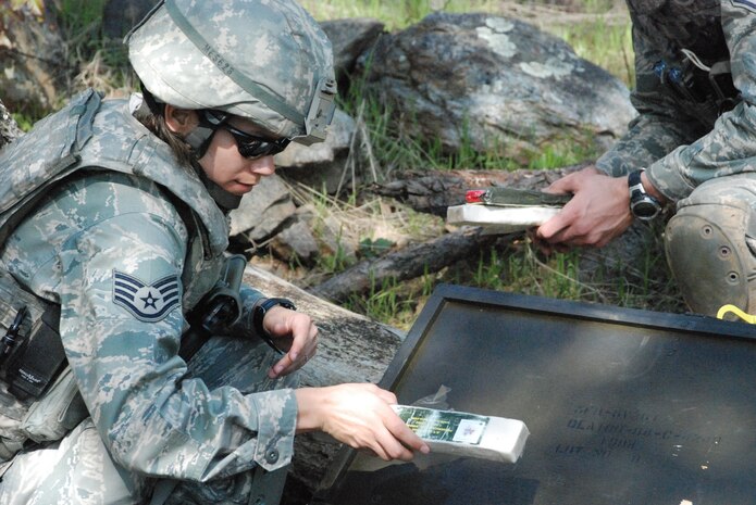 Staff Sgt. Victoria Menchaca, a 9th CES EOD flight member, places disposal devices inside a weapons cache March 24 during a training exercise. The EOD team uses the explosives to create a controlled detonation of a weapons cache. (Photo by Airman 1st Class Chuck Broadway)