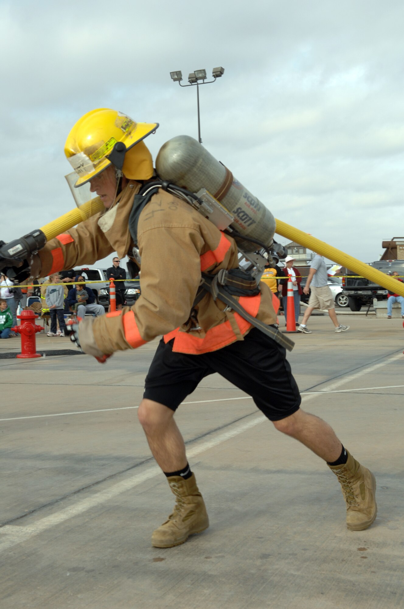 A competitor drags a charged 2/3 inch hose during the fifth portion of the Rookie Firefighter Combat Challenge March 21. (U.S. Air Force photo by Tech. Sgt. John Barton)