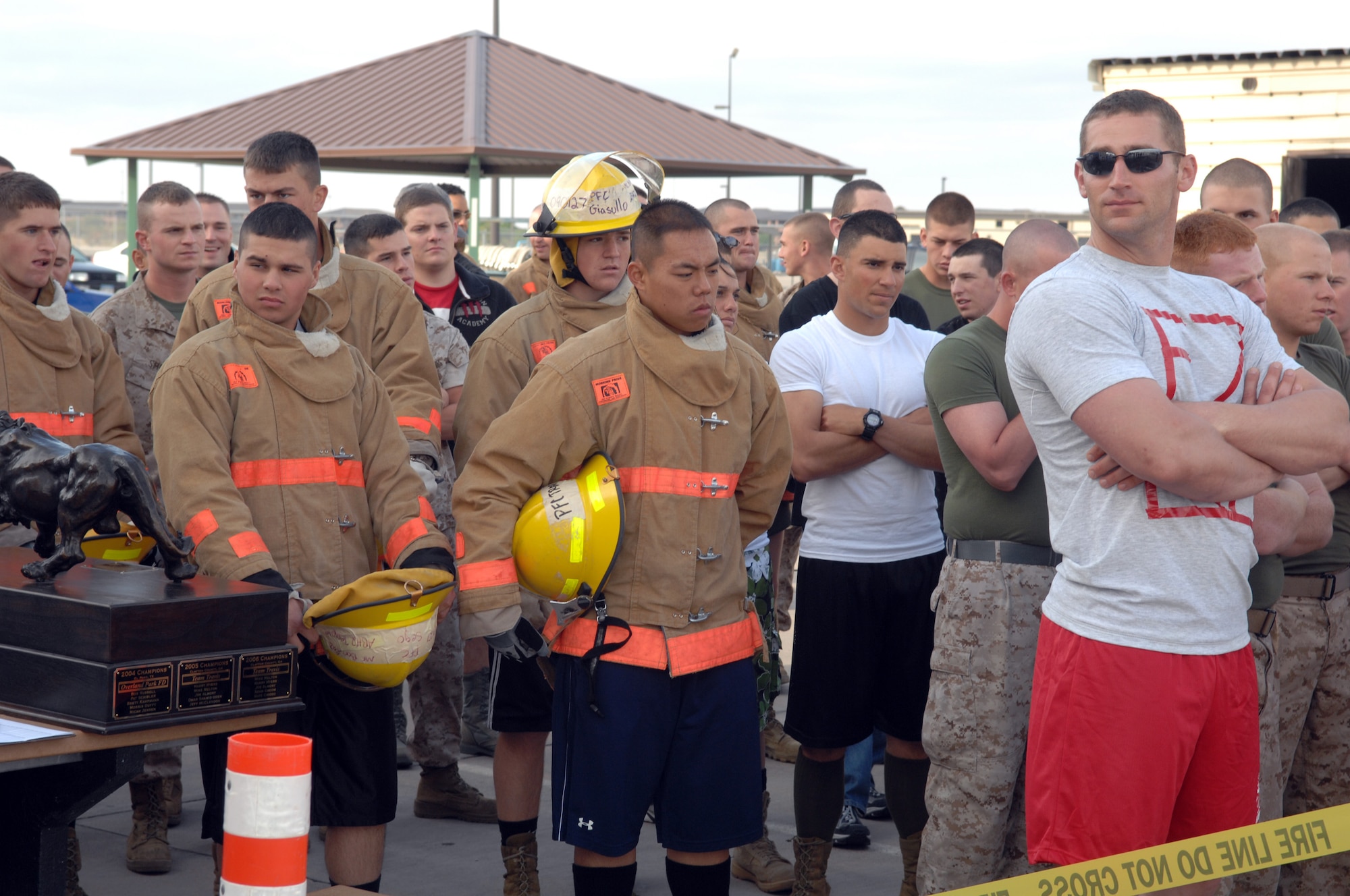 Competitors wait their turn to run the grueling course, often called the "toughest two minutes in sports." Competitors in the Rookie Firefighter Challenge must carry a 45-pound hose up five stories, hoist another 45-pound toolbox the same distance, move a 150-pound block of solid steel eight feet using only a sledgehammer, dodge fire hydrants, pull a charged 1 2/3-inch hose 100 feet and drag a 165-pound dummy more than 100 feet to the finish line. (U.S. Air Force photo by Tech. Sgt. John Barton)
