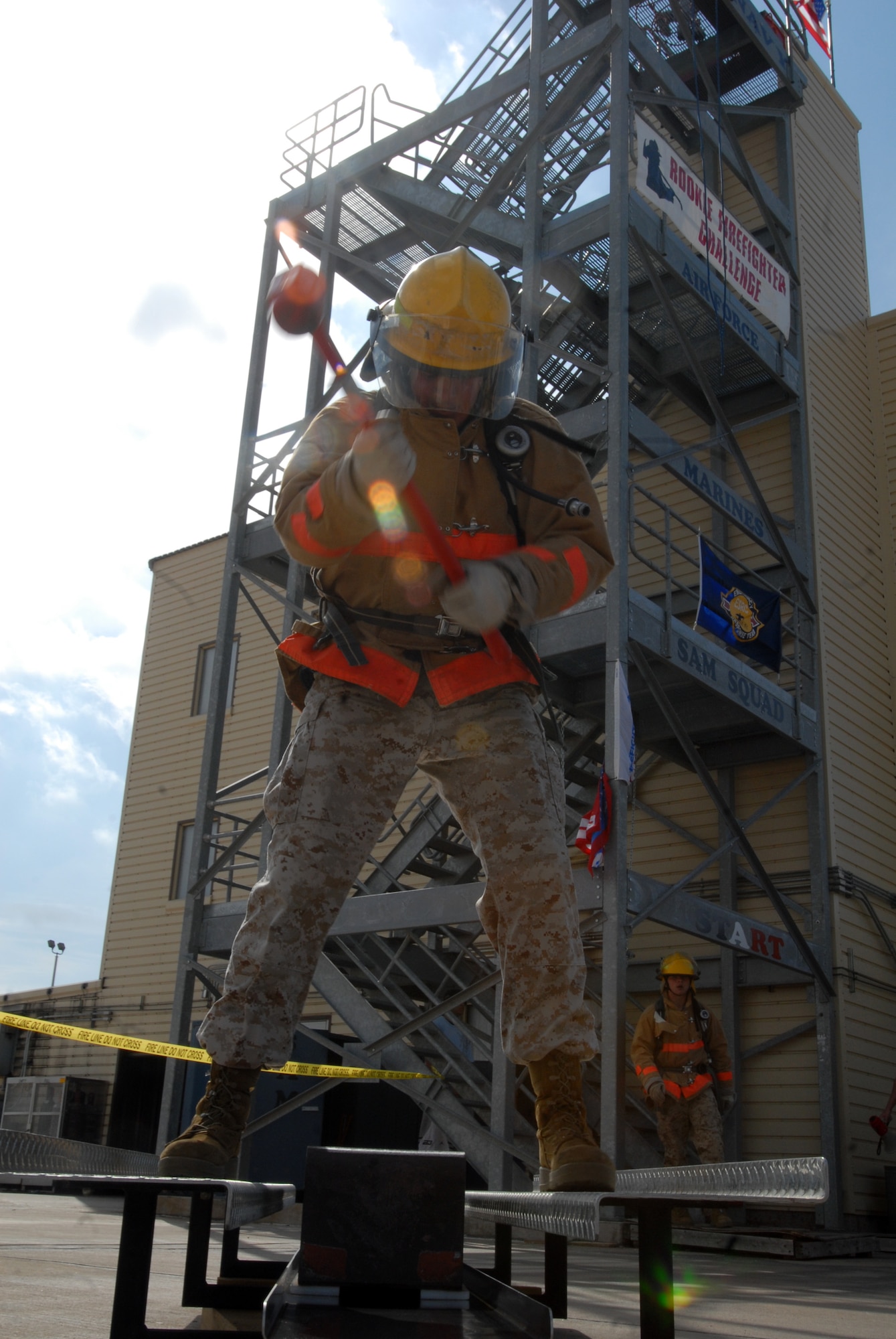 A Marine slams his mallet into the 150-pound block he is required to move during part three of the Rookie Firefighter Combat Challenge March 21. (U.S. Air Force photo by Airman Clayton Lenhardt)