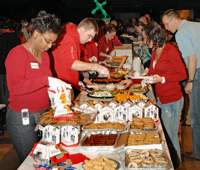 A cadre of volunteers prepare to serve dinner at the 11th Heroes Welcoming Heroes event March 19, 2009 at the National Museum of the United States Air Force.  More than 220 Airmen and their families enjoyed the  event, which honored recently deployed military members from Wright-Patterson Air Force Base and their families. (U.S. Air Force photo/Al Bright)
