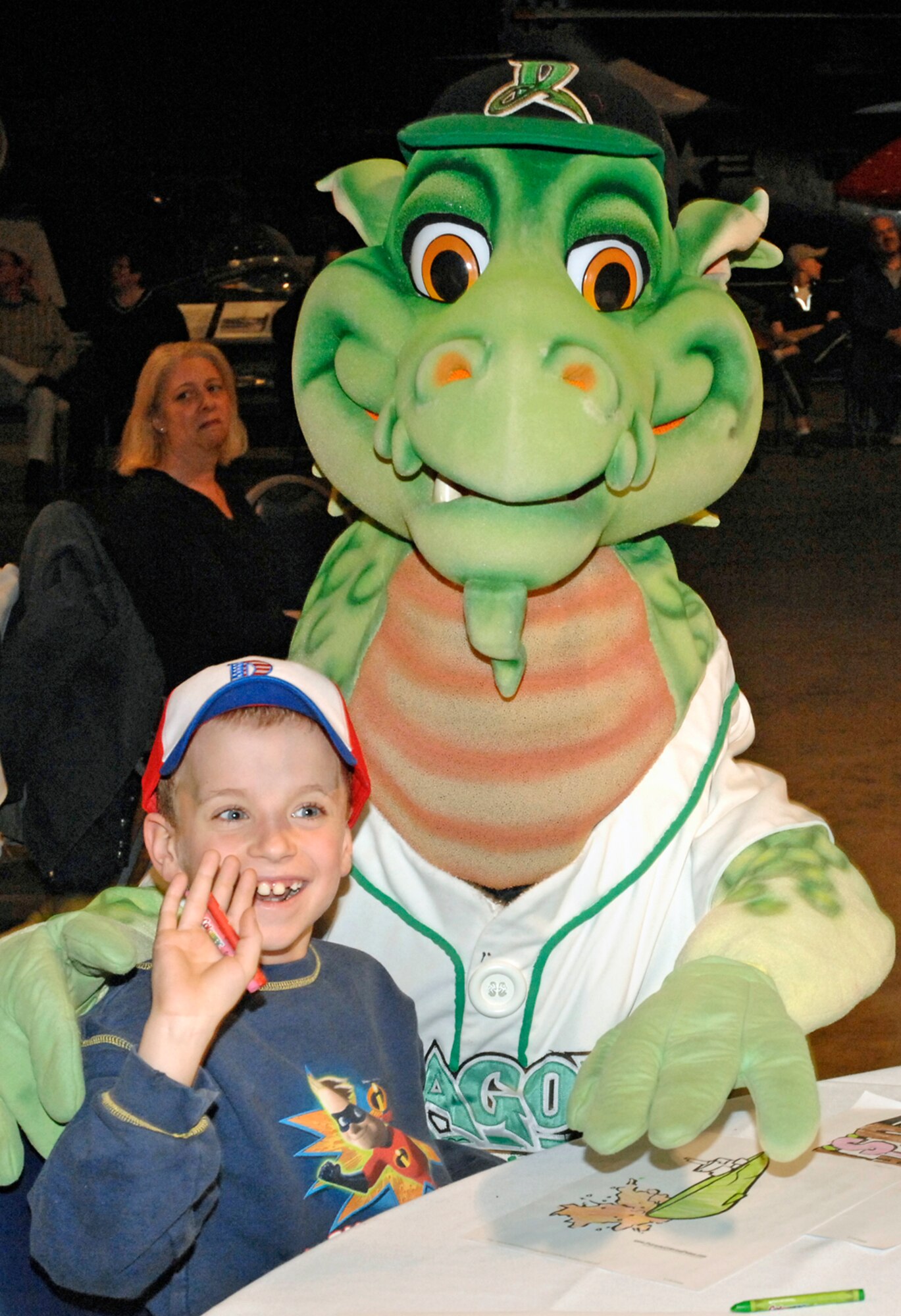 Dayton Dragons mascot Heater visits Alex O’Donnell at the Heroes Welcoming Heroes event March 19 at the National Museum of the United States Air Force.  More than 220 Airmen and their families enjoyed the  event, which honored recently deployed military members and their families.  Alex is the son of Robert and Maj. Tamara O’Donnell of Air Force Materiel Command at Wright-Patterson Air Force Base. (U.S. Air Force photo/Al Bright)
