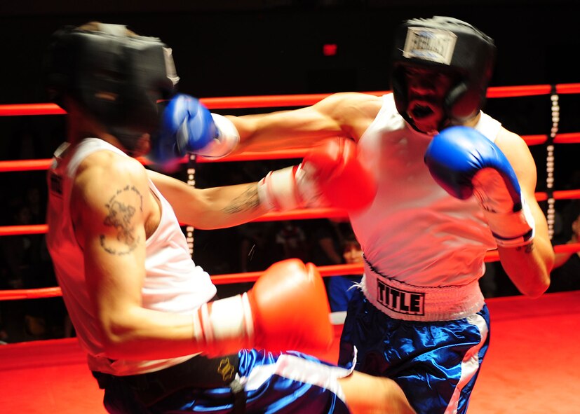 Airman 1st Class Willie Bivens, 49 Maintenance Squadron, lands a right hook to Senior Airman Chad Penn, 49 Force Support Squadron, at the Raptor Rumble 3 at Holloman Air Force Base, N.M., March 13. Airman Bivens won the fight by decision. (U.S. Air Force photo/ Airman 1st Class Deandre Curtiss)