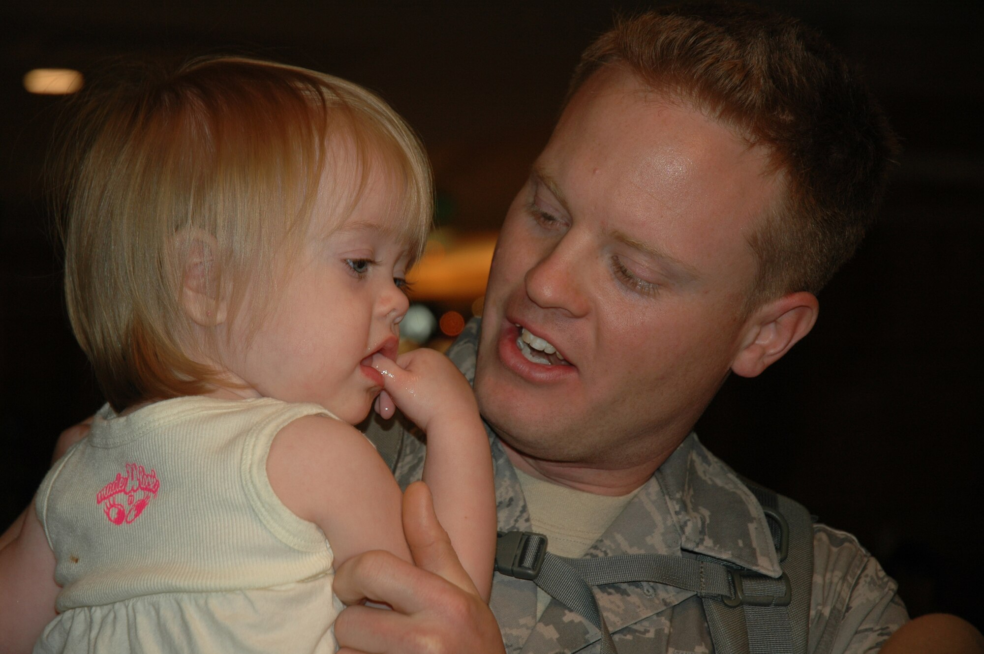 Staff Sgt. Simon Harrison, 944th Civil Engineer Squadron member, is greeted by his daughter, Charlize, March 17, 2009, at Phoenix Sky Harbor International Airport after returning from a deployment at Kirkuk Regional Air Base, Iraq. Sergeant Harrison, along with 23 other reservists from the 944th CES, spent six months away from their families and civilian jobs in support of overseas contingency operations. (U.S. Air Force photo/Tech. Sgt. Susan Stout) 