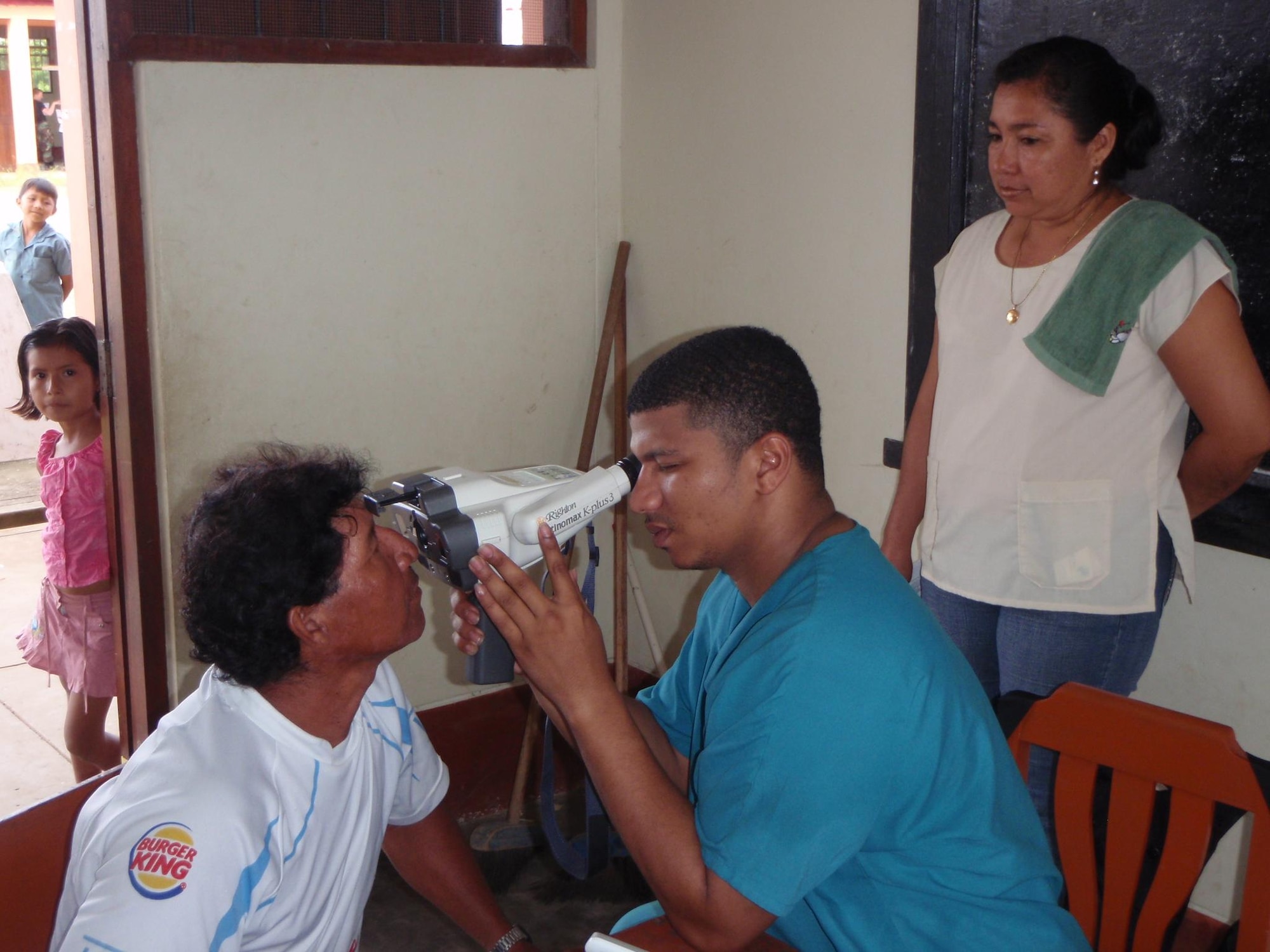 LORETO REGION, Peru -- Staff Sgt. Cristian Martinez, 96th Medical Group NCOIC of surgical services at Eglin Air Force Base, examines an optometry patient during a medical mission here March 12.  A team of 15 Air Force doctors and technicians, along with more than 50 Peruvian Navy, Ministry of Health, and civilian practitioners, treated patients in the remote region for two weeks as part of the ongoing Riverine Project, a three year humanitarian medical project sponsored by Twelfth Air Force (Air Forces Southern).  (U.S. Air Force photo by Master Sgt. Jesse Moreno)