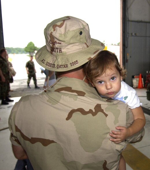 Technical Sergeant Karl W. Smith, embraces his daughter Grace Emily (18 months) at a welcome home ceremony for deployed personnel at Pease Air National Guard Base, New Hampshire on July 18th, 2003.  Personnel from the 157th Air Refueling Wing deployed to Al Udeid Air Base, Qatar during the summer of 2003 in support of Operation Iraqi Freedom.  Tech Sgt. Smith is an avionics specialist assigned to the 157th Maintenance Squadron at Pease.  (U.S. Air Force photo/Senior Airman Curtis J. Lenz)