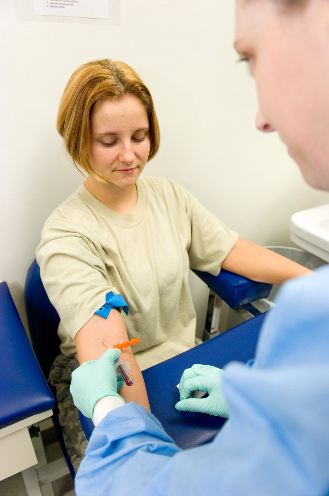 Tech. Sgt. Jamie Disney draws blood March 19 from Staff Sgt. Natosha Nordquist March 19 at Yokota Air Base, Japan. Both sergeants are from the 374th Medical Support Squadron here. The 374th Medical Group clinical laboratory received accreditation from the College of American Pathologists recently. (U.S. Air Force photo/Osakabe Yasuo)