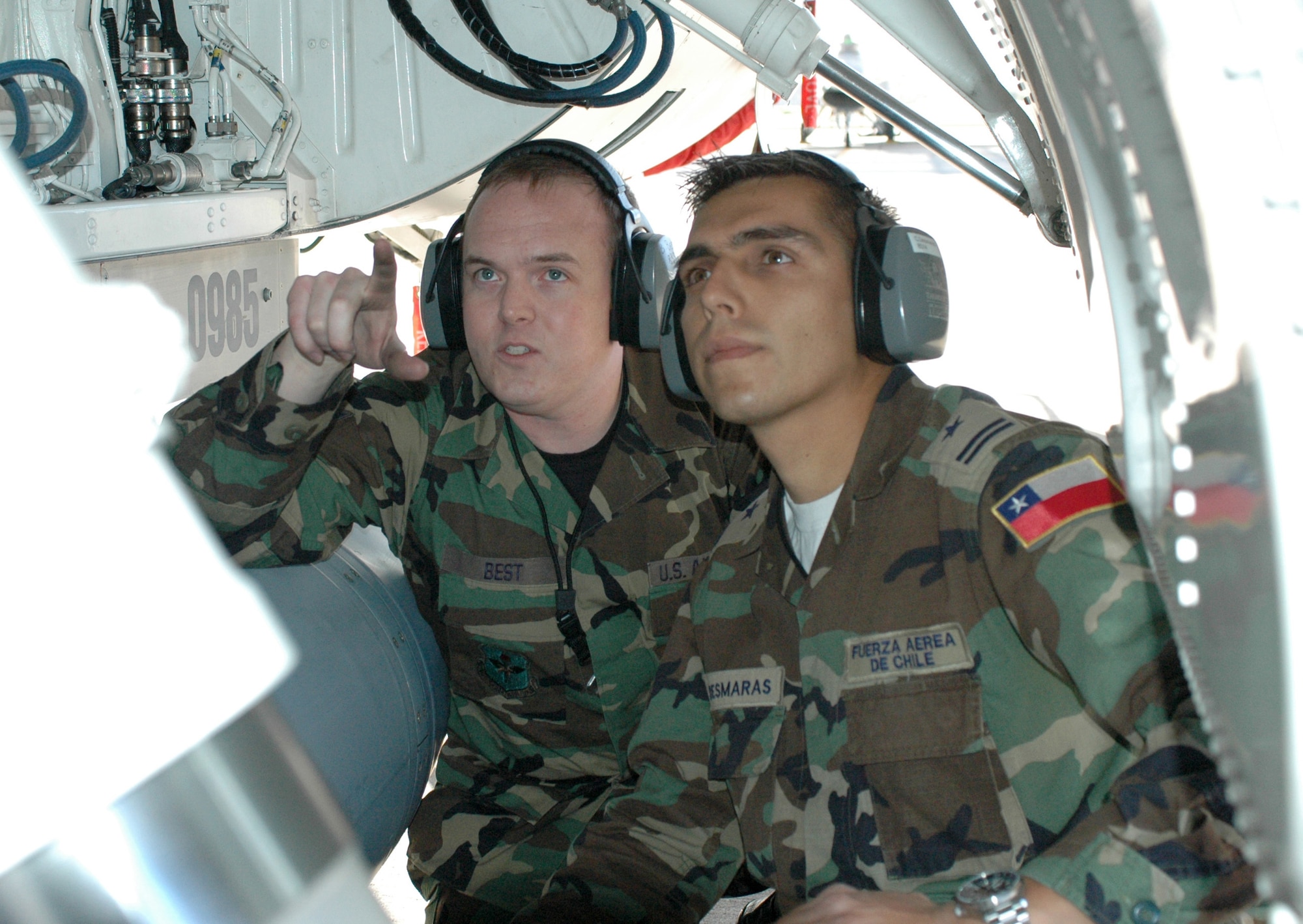 Staff Sgt. Bryon Best, left, an F-16 crew chief assigned to the 162nd Fighter Wing in Tucson, goes over maintenance issues with Chilean Air Force exchange officer 1st Lt. Cristobal Desmaras. The lieutenant spent two years with the Arizona Air Guard unit to learn F-16 maintenance practices. (Air National Guard photo by Capt. Gabe Johnson)