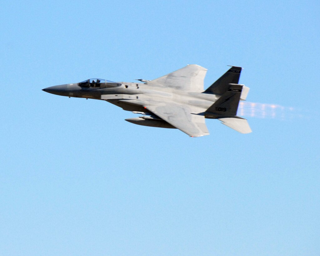 An F-15 Eagle flies over the flight line as aircraft sorties are generated at Base X in support of an Operational Readiness Exercise (ORE) Phase II at the 125th Fighter Wing, JIA, Florida, June 21, 2009.  The ORE phase II analyzes the unit's capability to fight and survive from a deployed base. (Air National Guard Photo by Tech. Sgt. Jeff Trumble)