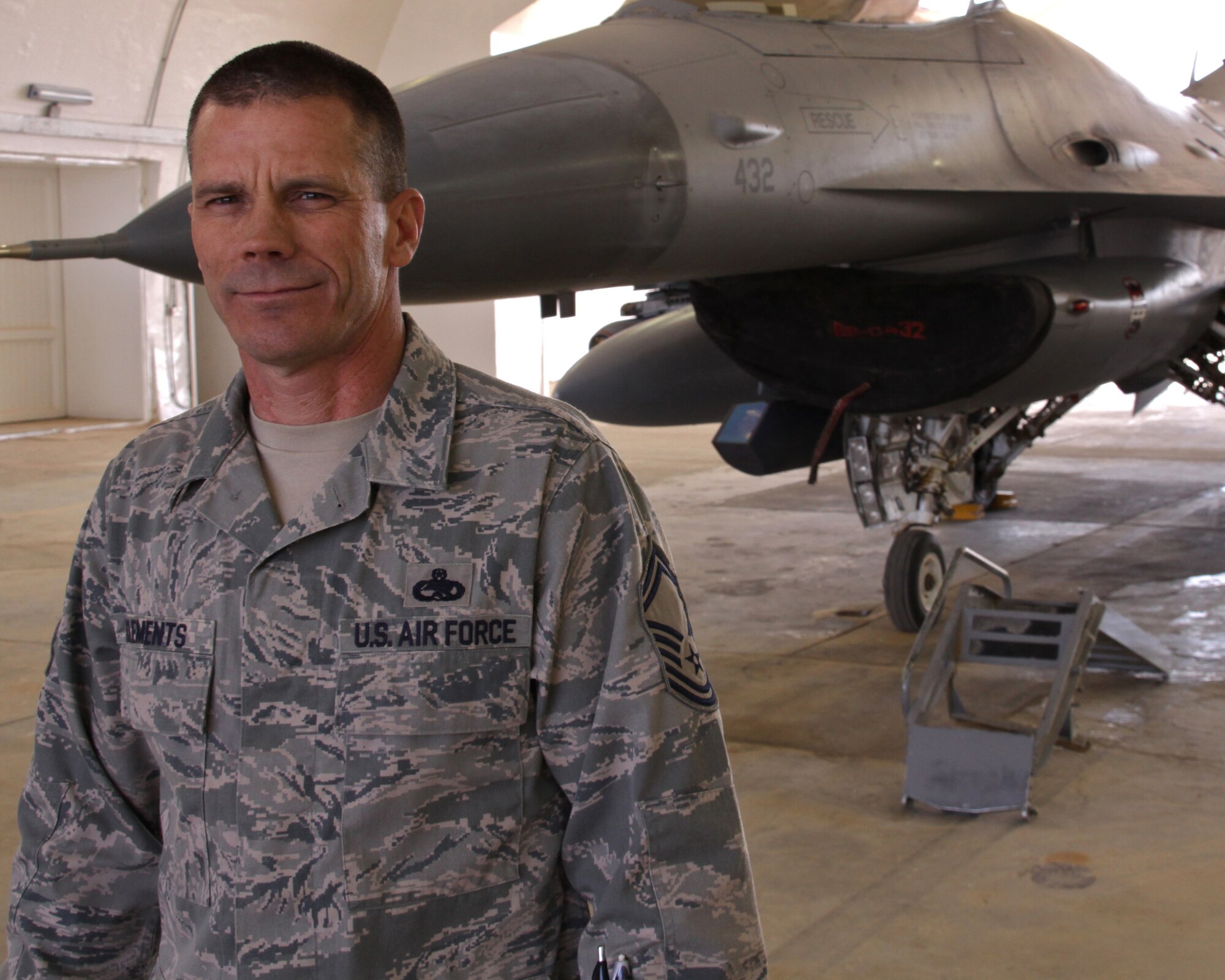 Senior Master Sgt. Scott Clements, 4th Aircraft Maintenance Unit productions supervisor, stands in front of an F-16 Fighting Falcon at Joint Base Balad, Iraq, March 2, 2009. Sergeant Clements was in an accident four years ago, which resulted in a below-the-knee amputation on his left leg. He uses a prosthetic leg, but it does not stop him from being the fight. (U.S. Air Force photo/Tech. Sgt. Lionel Castellano)