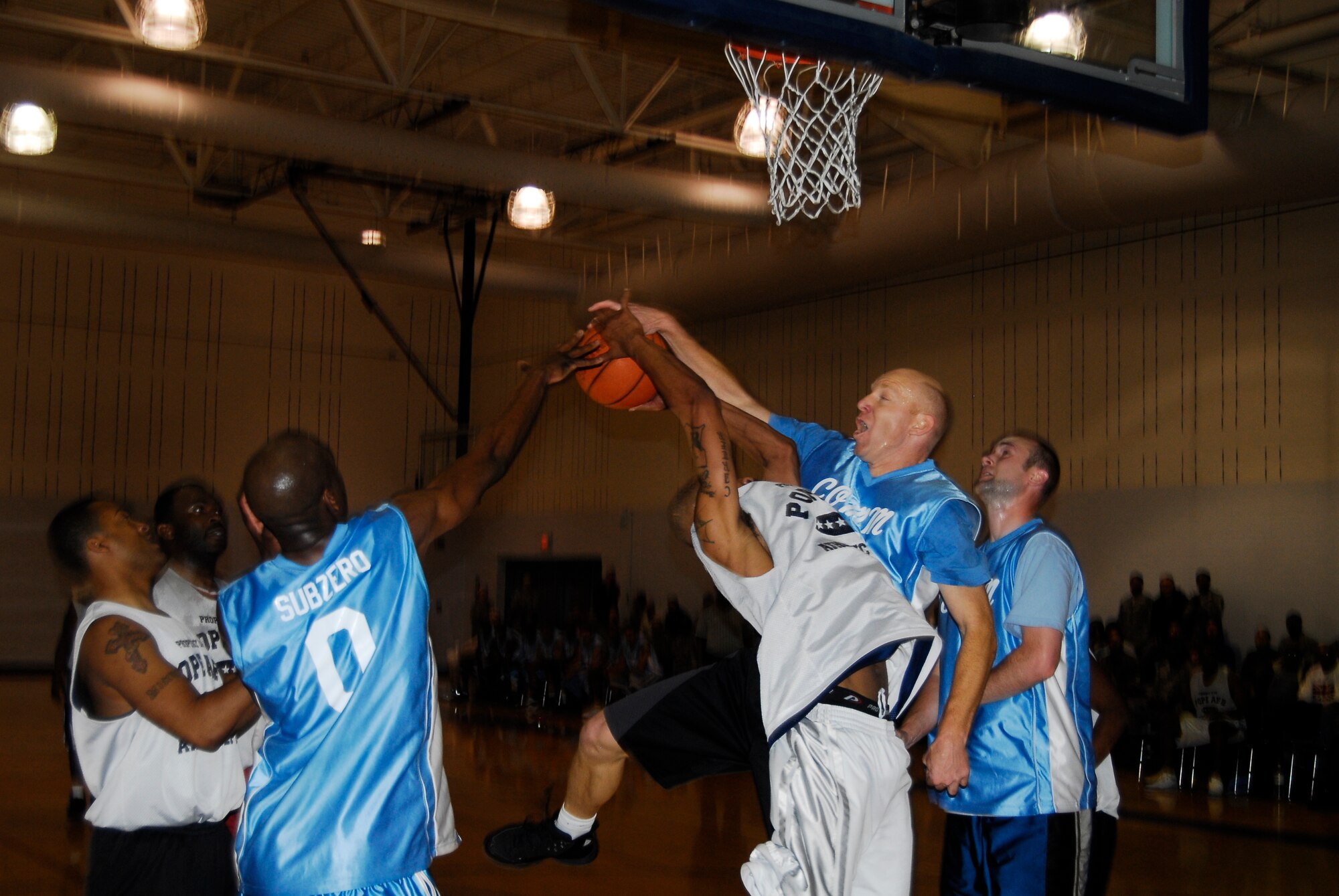Bradley Barnhart, 43rd Communications Squadron, blocks the lay up attempt by Kenneth Carter, 43rd Logistics Readiness Squadron, in the Pope Intramural Basketball Championship Game March 6. (U.S. Air Force Photo by Irvin Gourdine)