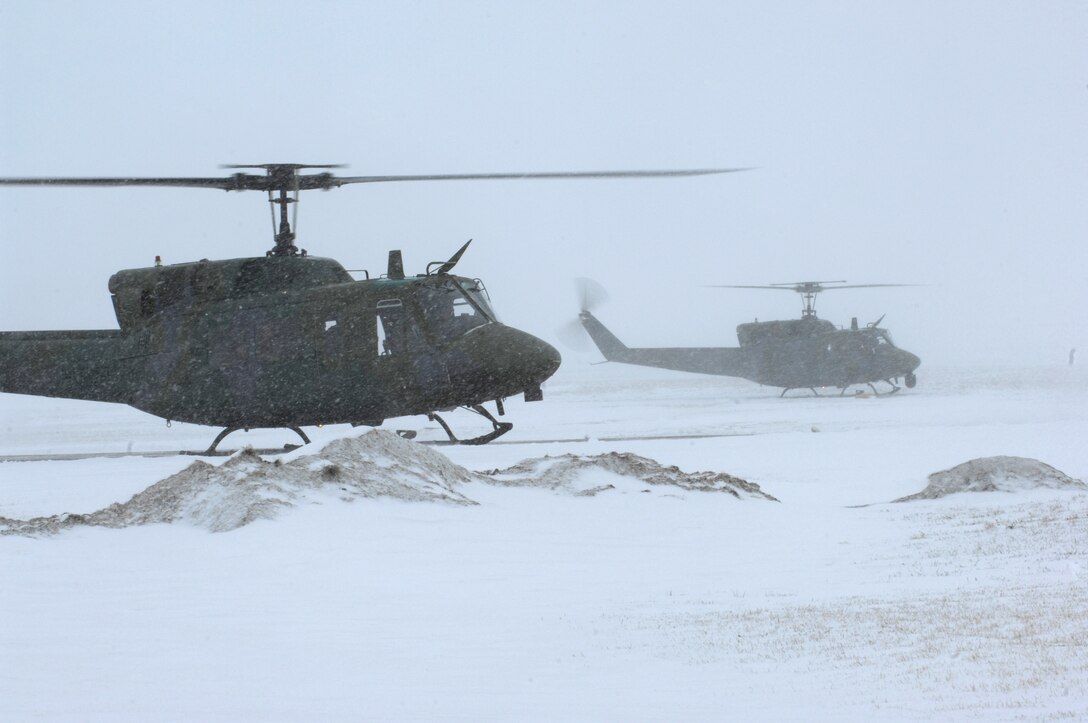 A pair of UH-1N Huey helicopters take off for Bismarck, N.D., March 25 from Minot Air Force Base, N.D., to assist in flood relief efforts.  Eight crewmembers and the two helicopters from the 54th Helicopter Squadron deployed to aid the relief efforts. (U.S. Air Force photo/Senior Airman Joe Rivera) 
