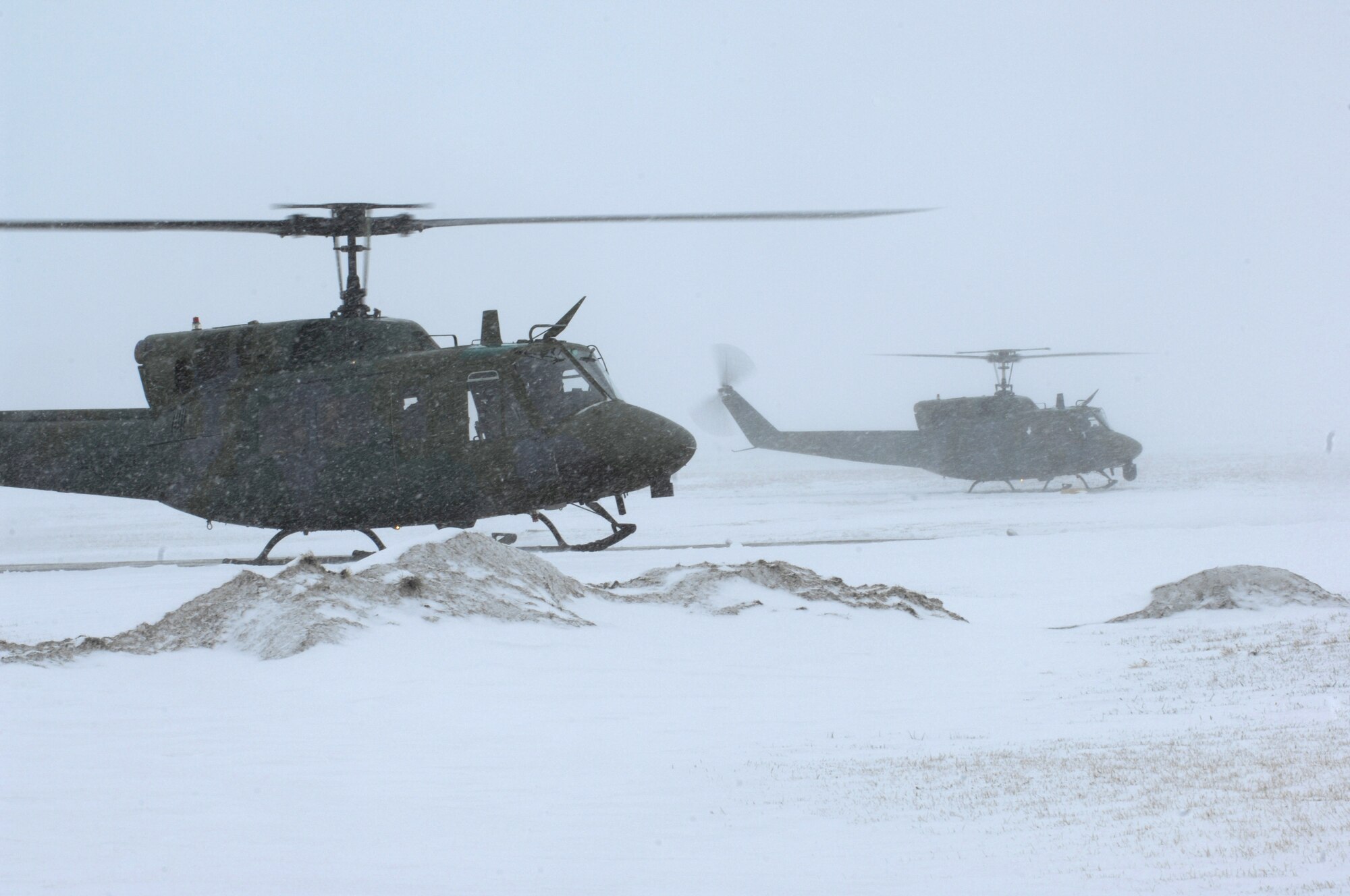 A pair of UH-1N Huey helicopters take off for Bismarck, N.D., March 25 from Minot Air Force Base, N.D., to assist in flood relief efforts.  Eight crewmembers and the two helicopters from the 54th Helicopter Squadron deployed to aid the relief efforts. (U.S. Air Force photo/Senior Airman Joe Rivera) 
