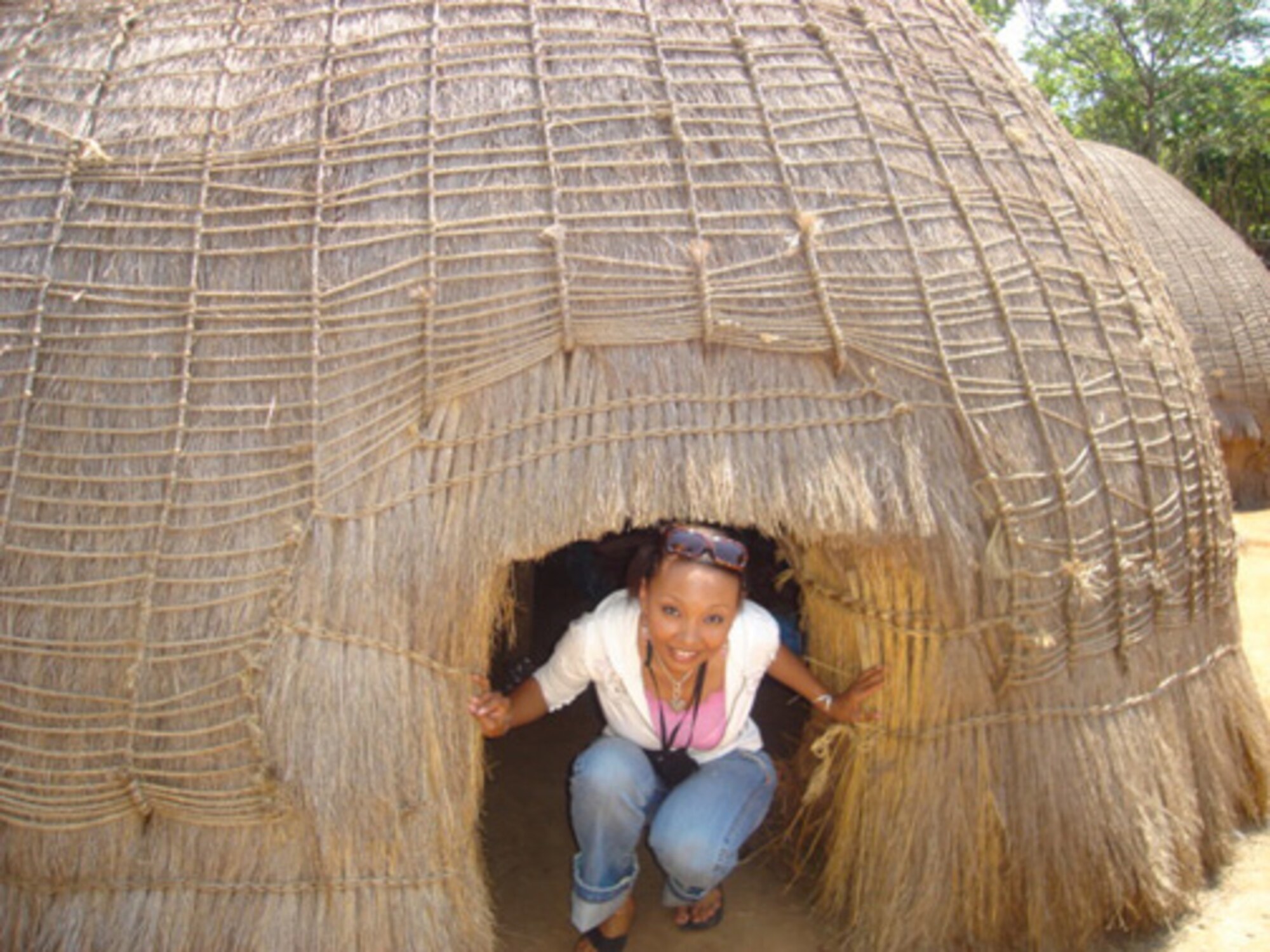 Tech. Sgt. Dawn Scott, 512th Logisitcs Readiness Squadron supply management specialist, visited a local mud-hut home in Swaziland, Africa. She and her family lived in Africa during her duty as an American diplomat to the U.S. Embassy in Swaziland. She and her family returned to Africa months later after Sergant Scott took a job as human resources director to the U.S. Embassy in Tunisia. (submitted photo)                                