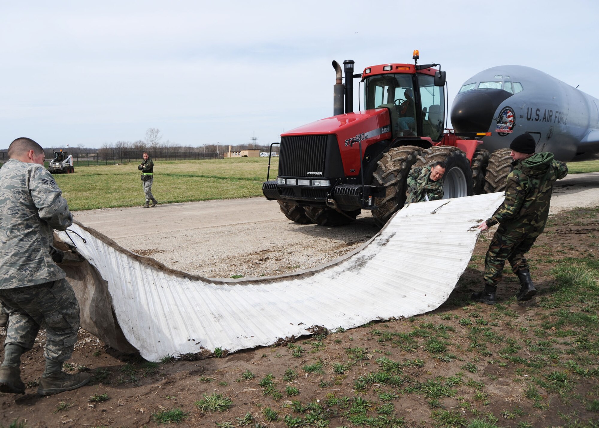 SCOTT AIR FORCE BASE, Ill. --Team Scott personnel move a KC-135 into the grass on the Scott Field Heritage Airpark with the aid of mobi-mats March 25. Team Scott members from the 375th Airlift Wing and the 126th Air Refueling Wing moved the KC-135 into place at the Scott Field Heritage Airpark. (U.S. Air Force photo/Tech. Sgt. Michelle Larche) 