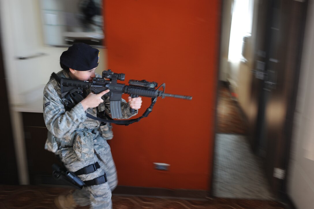 Airman 1st Class Elizabeth Bolanos, 28th Security Forces Squadron, performs a dynamic entry to clear a room with potential hostiles with her M-4 carbine during a in  flight exercise held here, March 25.  Dynamic entries are used for high-risk, incidents that could require the use of armed force to quell the situation. (U.S. Air Force photo/Airman 1st Class Adam Grant)