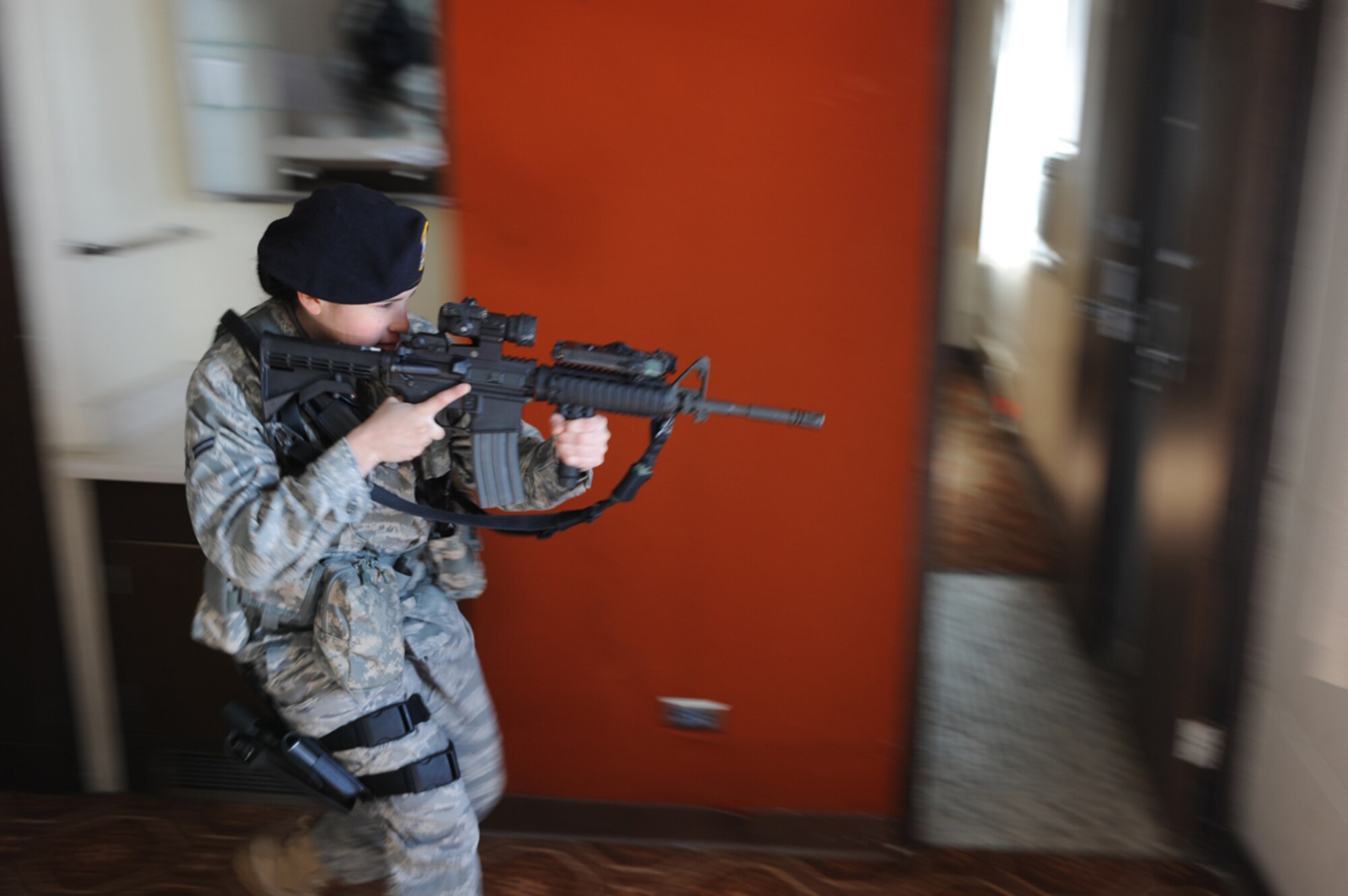 Airman 1st Class Elizabeth Bolanos, 28th Security Forces Squadron, performs a dynamic entry to clear a room with potential hostiles with her M-4 carbine during a in  flight exercise held here, March 25.  Dynamic entries are used for high-risk, incidents that could require the use of armed force to quell the situation. (U.S. Air Force photo/Airman 1st Class Adam Grant)
