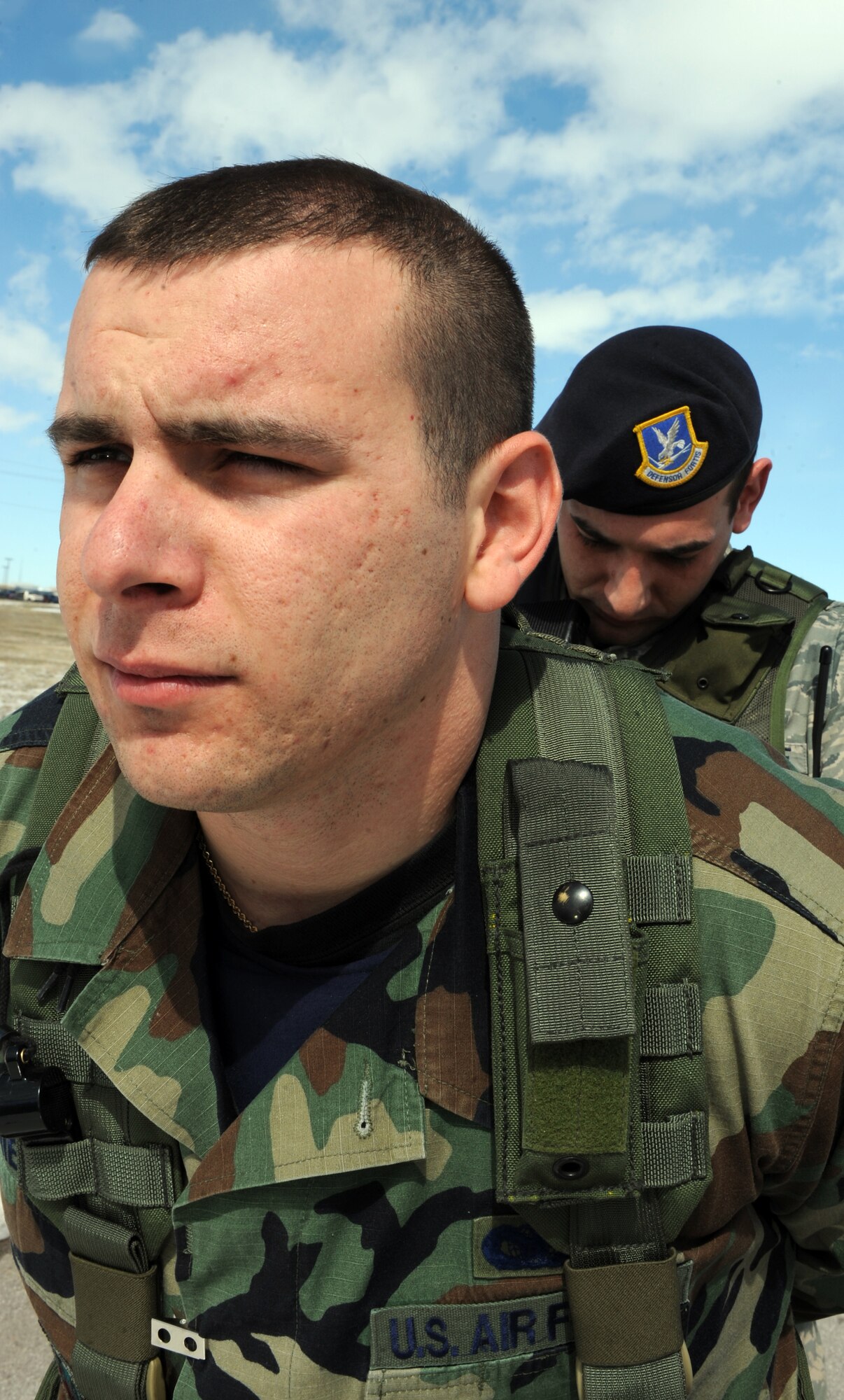 (Right) Staff Sgt. Marc Muzio, 28th Security Forces Squadron team leader, simulates placing handcuffs on another Airman during simulation of a high- risk traffic stop here, March 25. Security forces members routinely conduct exercises such as high- risk traffic stops while providing rapid, decisive and sustainable mission support. (U.S. Air Force photo/Airman 1st Class Adam Grant)

