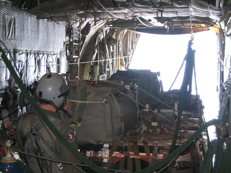 A loadmaster from the 96th Airlift Squadron readies the LCADS and SWAD sytems for an airdrop in Arizona.