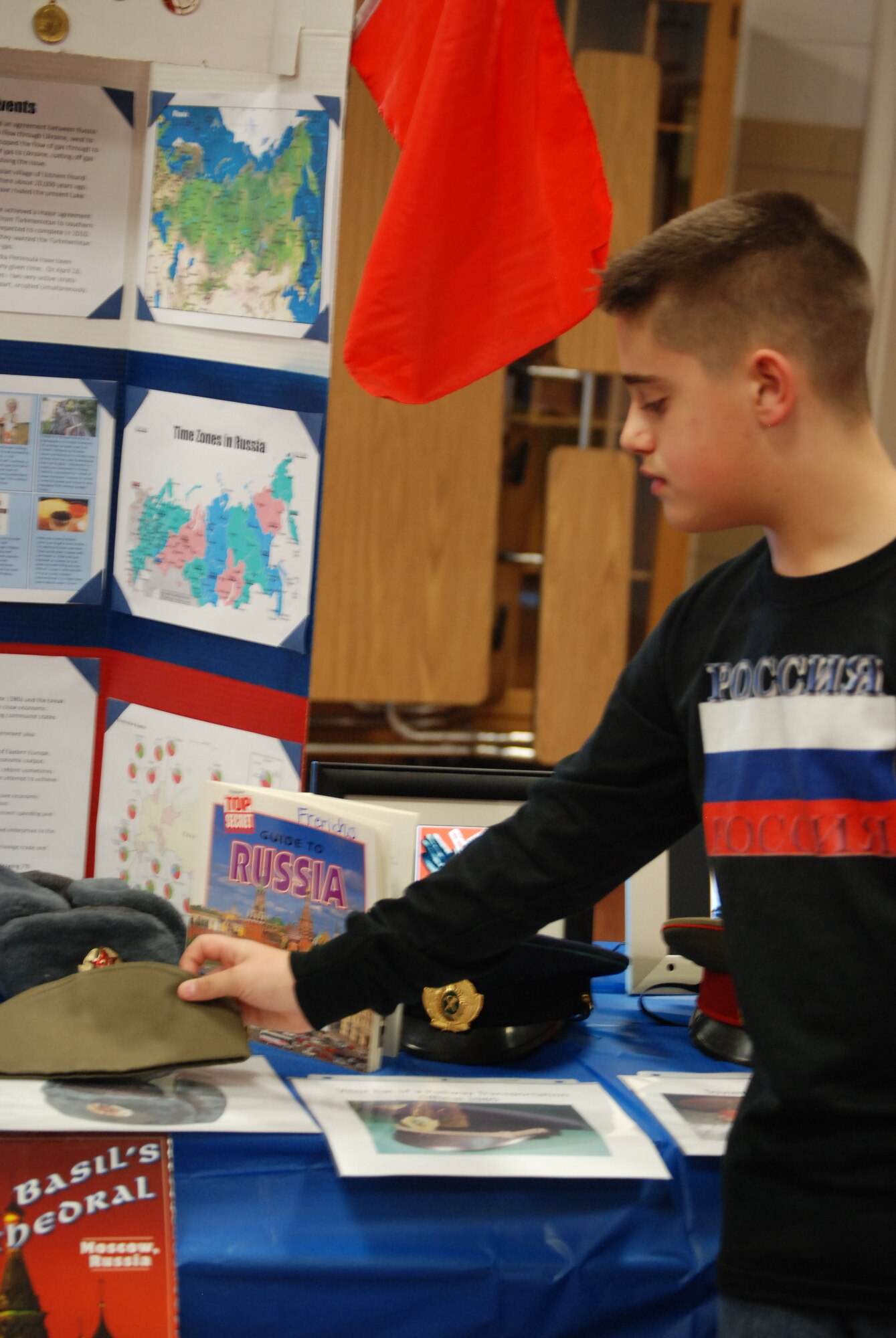 Jonathan Leonard, a 6th grade student at Sheppard Elementary, explains the purpose of the Russian pilotka used in WWII and the post war at the International Fair March 24. The International Fair exposed children to different cultures through food and displays. (U.S. Air Force photo/Airman 1st Class Valerie Hosea)