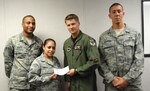 Airman 1st Class Jonathan Hunter (left), Team Randolph Airman's Council president, Airman 1st Class Amanda Finigan, TRAC vice president, and Senior Airman Michael Claiborne (right), TRAC secretary, present a check for $1,141 to Maj. Andrew Quinn, Team Randolph Air Force Assistance Fund project officer. The TRAC sponsored a golf tournament on March 20 to raise funds for the AFAF. (US Air Force photo by Staff Sgt. Beth Del Vecchio) 